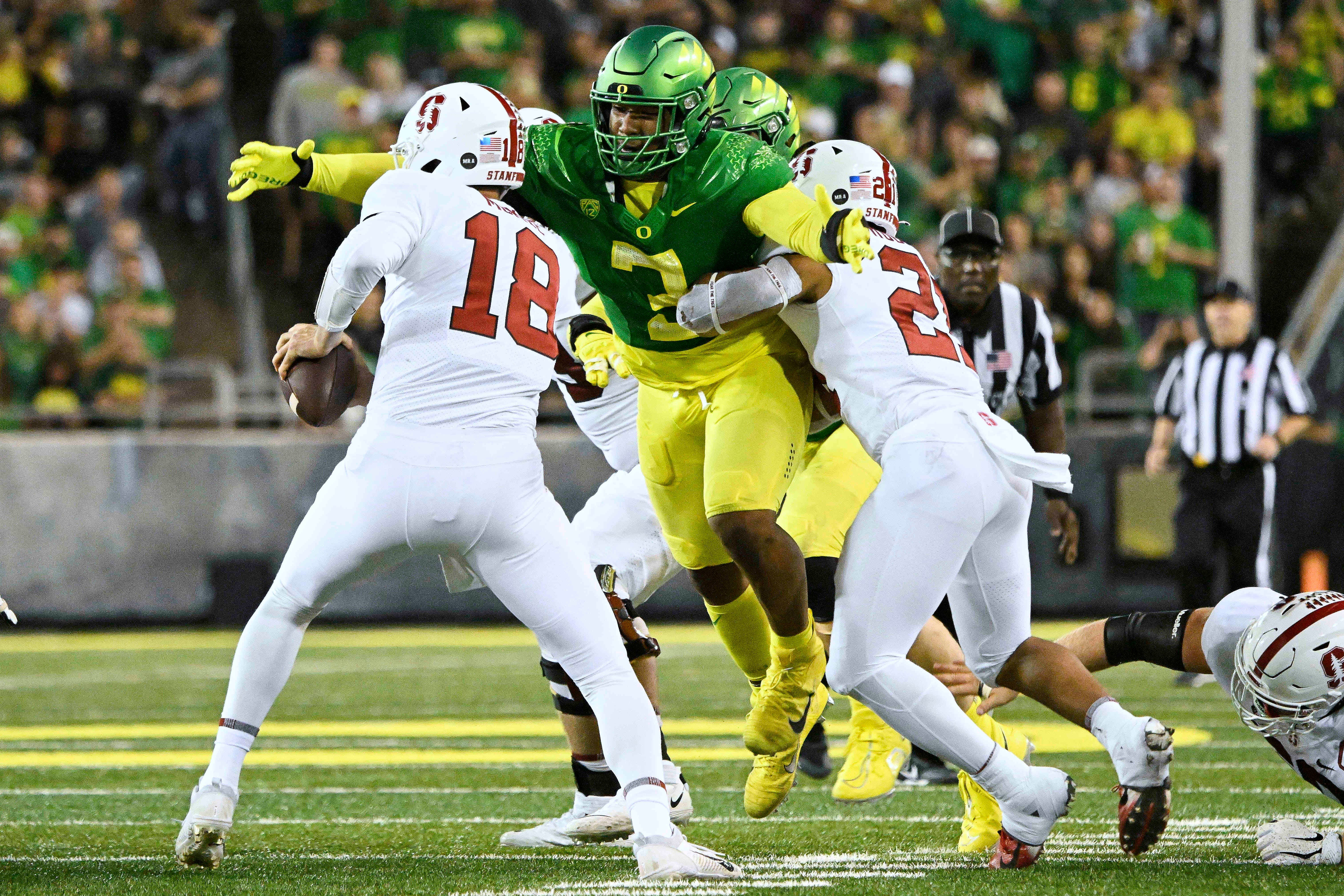 Oct 1, 2022; Eugene, Oregon, USA; Oregon Ducks defensive end Brandon Dorlus (3) sacks Stanford Cardinal quarterback Tanner McKee (18) during the second half at Autzen Stadium. The Ducks won the game 45-27.