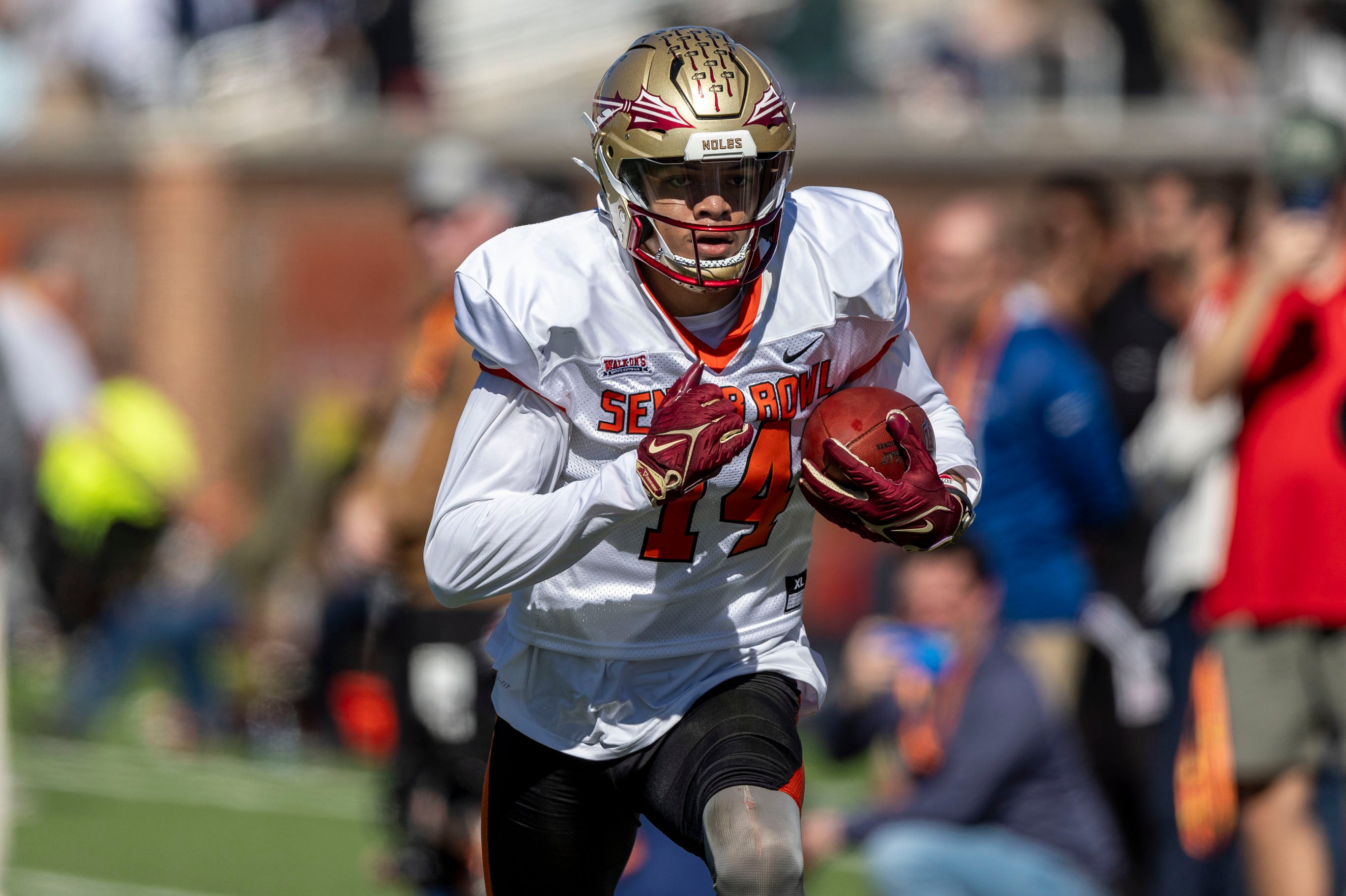 Jan 31, 2024; Mobile, AL, USA; American wide receiver Johnny Wilson of Florida State (14) runs after a catch during practice for the American team at Hancock Whitney Stadium.