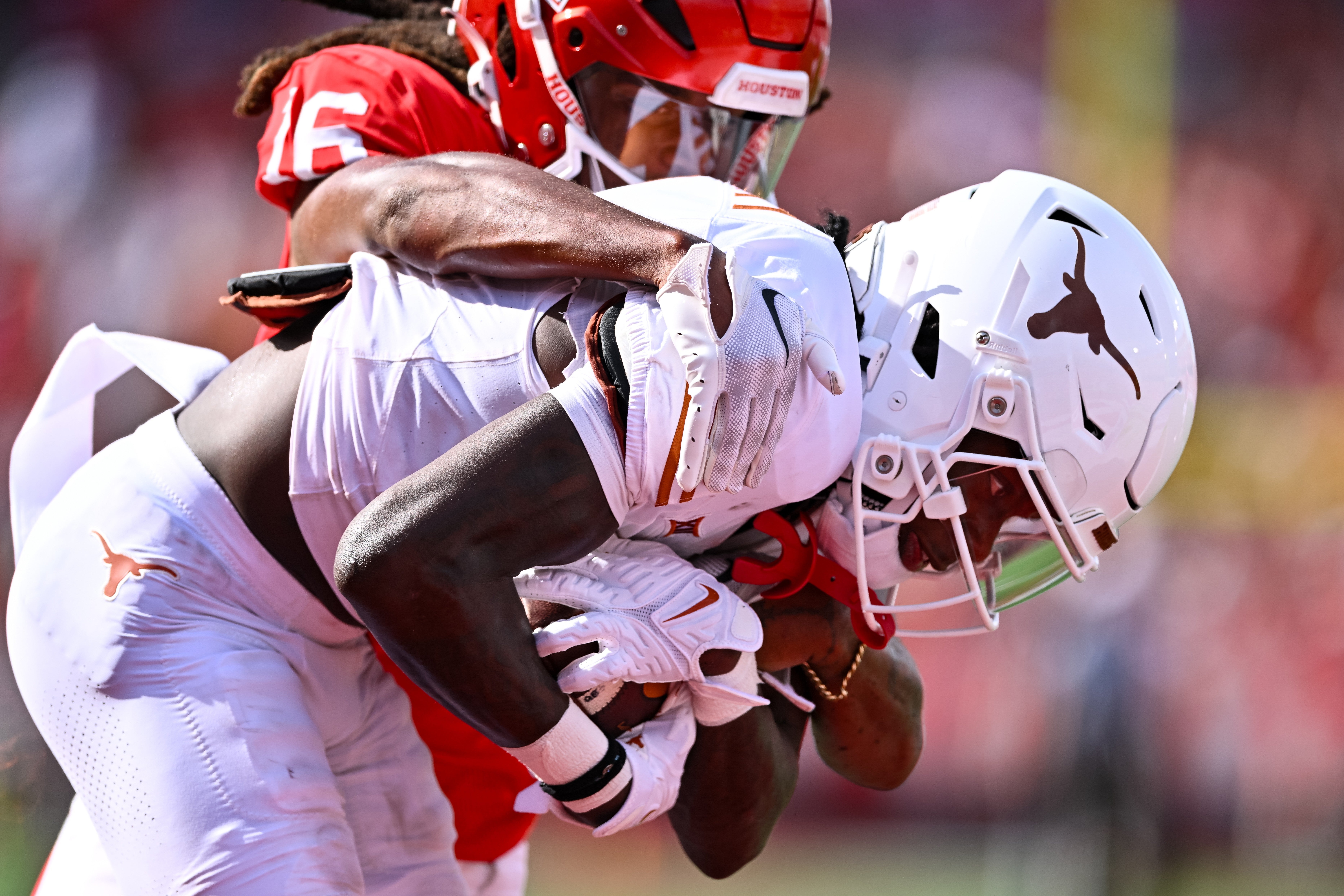 Oct 21, 2023; Houston, Texas, USA; Texas Longhorns wide receiver Xavier Worthy (1) receives a pass for a touchdown during the first quarter as Houston Cougars defensive back Brian George (16) defends at TDECU Stadium.