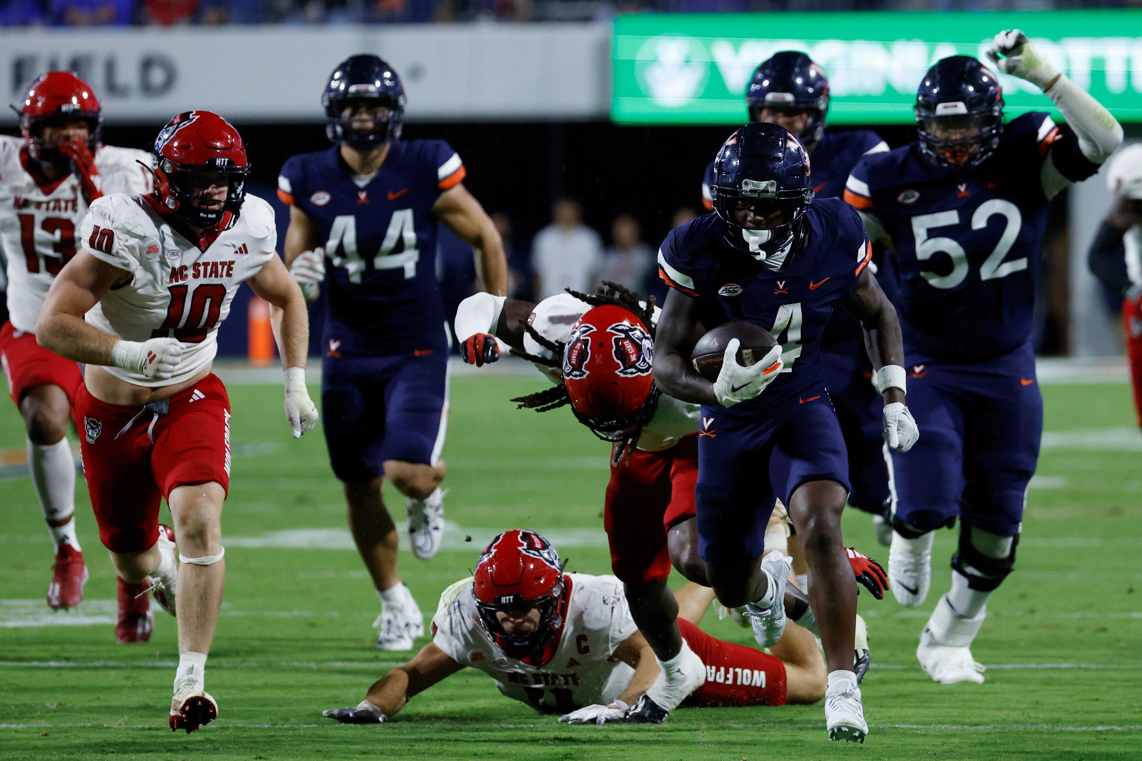 Sep 22, 2023; Charlottesville, Virginia, USA; Virginia Cavaliers wide receiver Malik Washington (4) runs with the ball past /no/ during the third quarter at Scott Stadium.