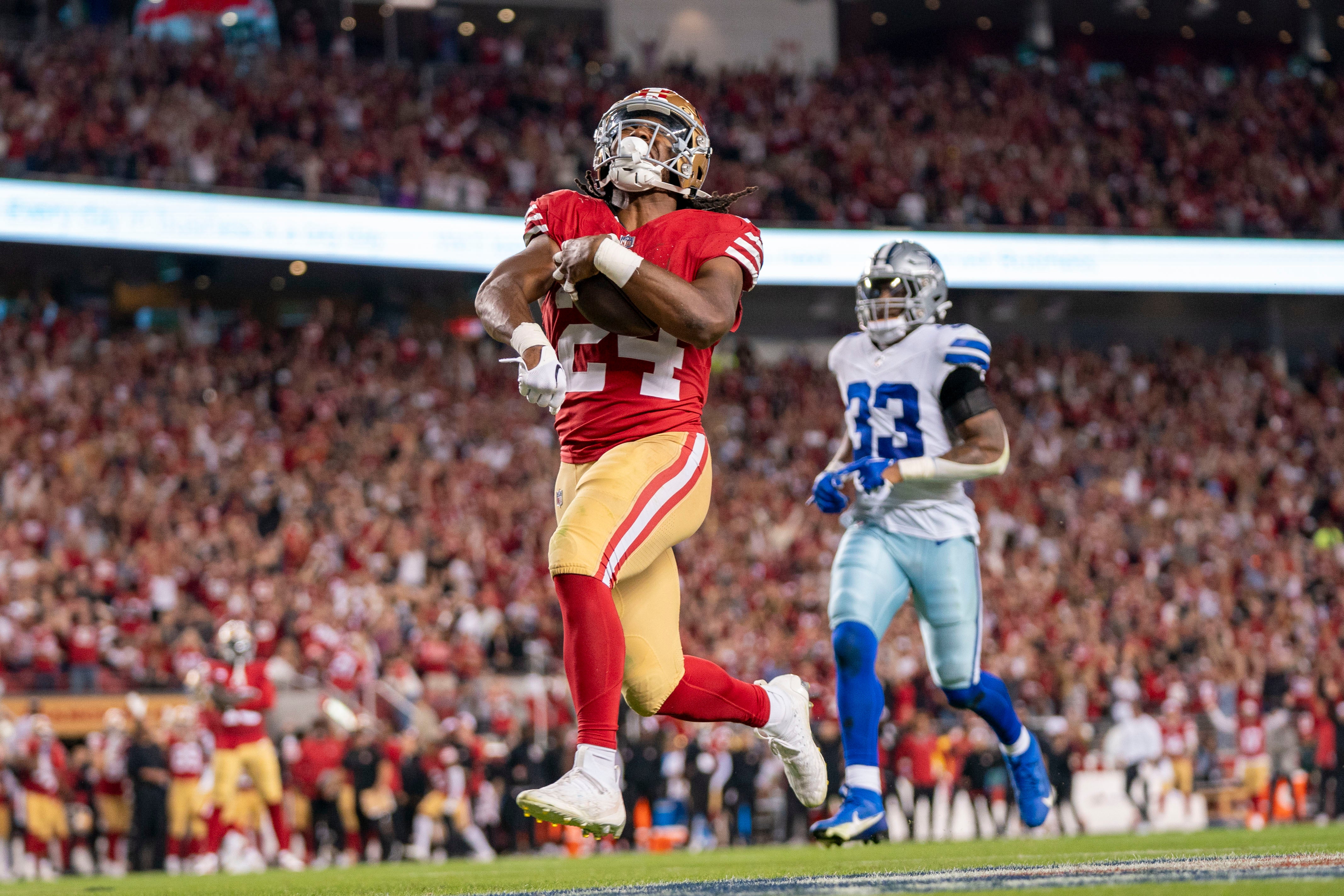 October 8, 2023; Santa Clara, California, USA; San Francisco 49ers running back Jordan Mason (24) scores a touchdown against Dallas Cowboys linebacker Damone Clark (33) during the fourth quarter at Levi's Stadium.