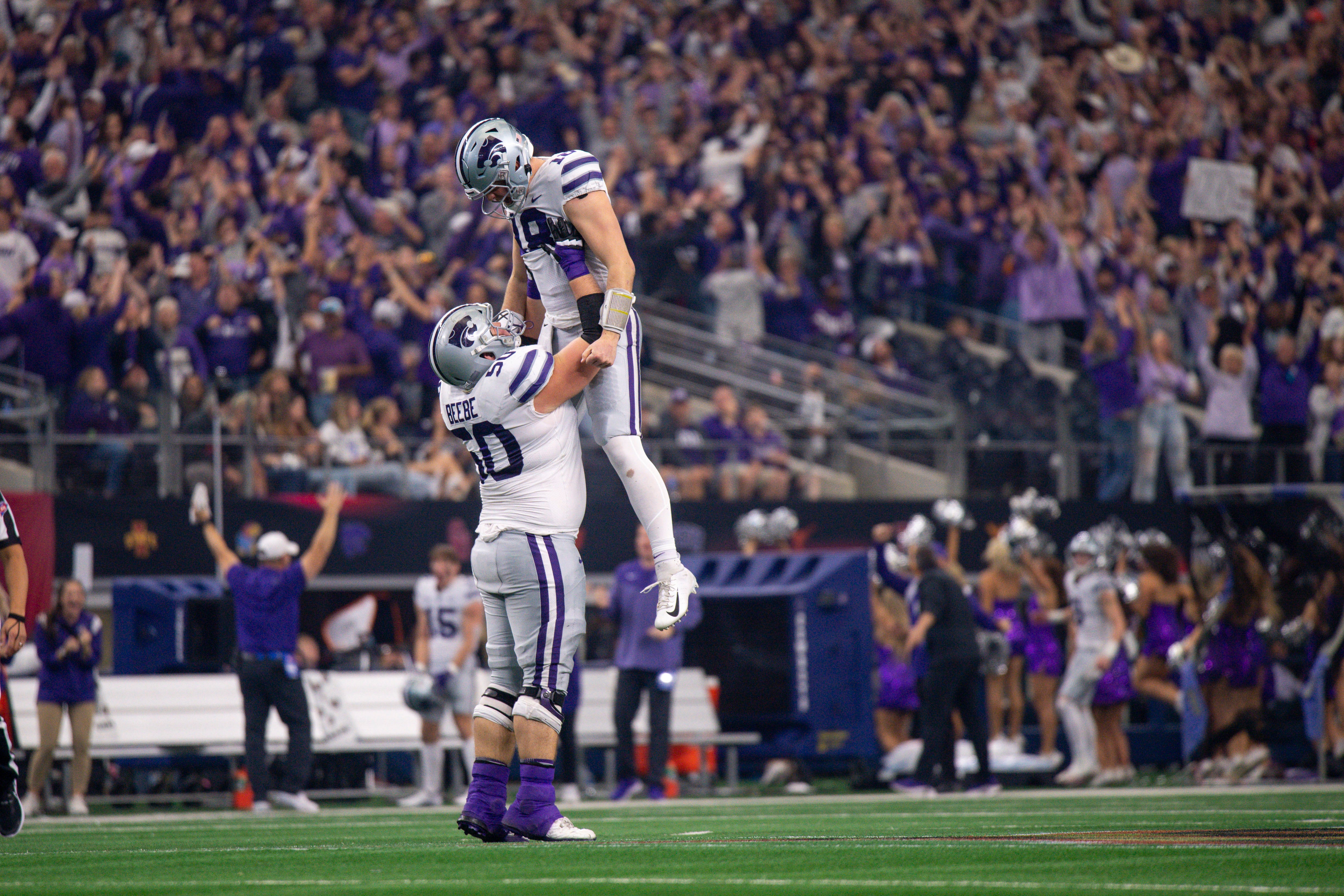 Kansas State Wildcats offensive lineman Cooper Beebe (50) and quarterback Will Howard (18) celebrate a touchdown against the TCU Horned Frogs during the second half at AT&T Stadium.