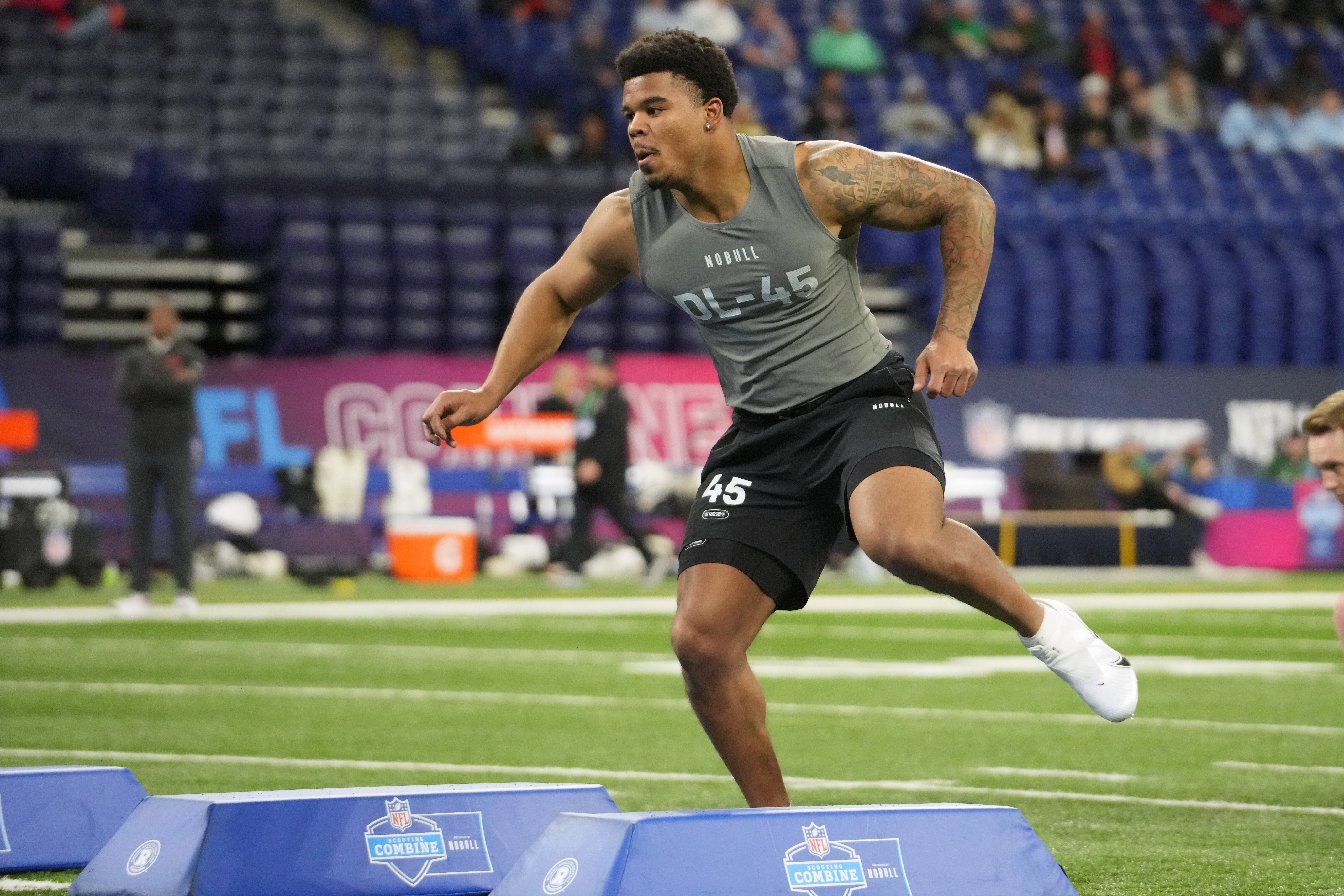 Caption: Feb 29, 2024; Indianapolis, IN, USA; Penn State defensive lineman Chop Robinson (DL45) works out during the 2024 NFL Combine at Lucas Oil Stadium.
