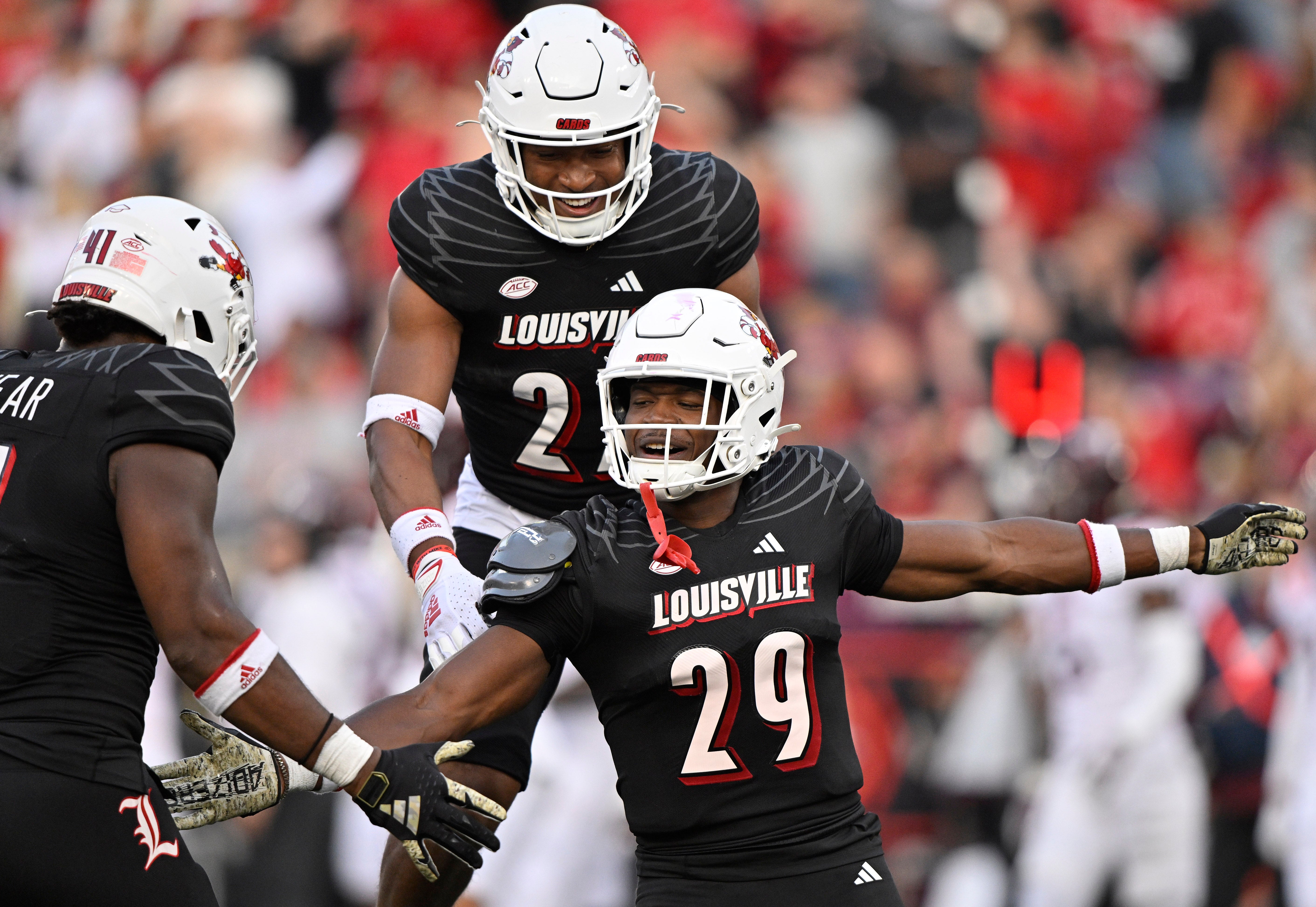 Nov 4, 2023; Louisville, Kentucky, USA; Louisville Cardinals defensive back Storm Duck (29) celebrates with defensive lineman Ramon Puryear (41) and defensive back Devin Neal (27) during the second half against the Virginia Tech Hokies at L&N Federal Credit Union Stadium. Louisville defeated Virginia Tech 34-3.