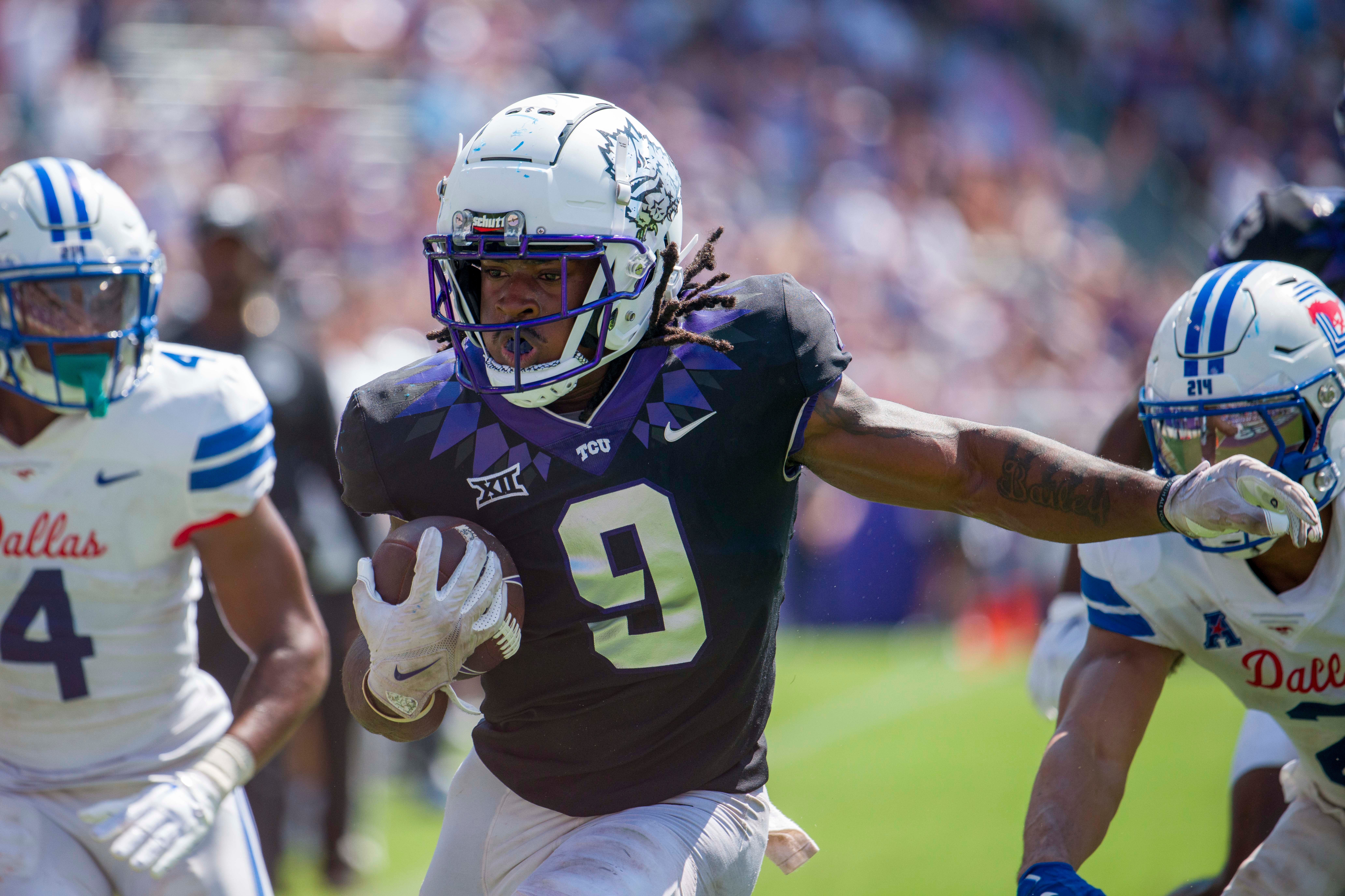 Sep 23, 2023; Fort Worth, Texas, USA; TCU Horned Frogs running back Emani Bailey (9) attempt to elude SMU Mustangs linebacker Kobe Wilson (24) during the second half at Amon G. Carter Stadium.