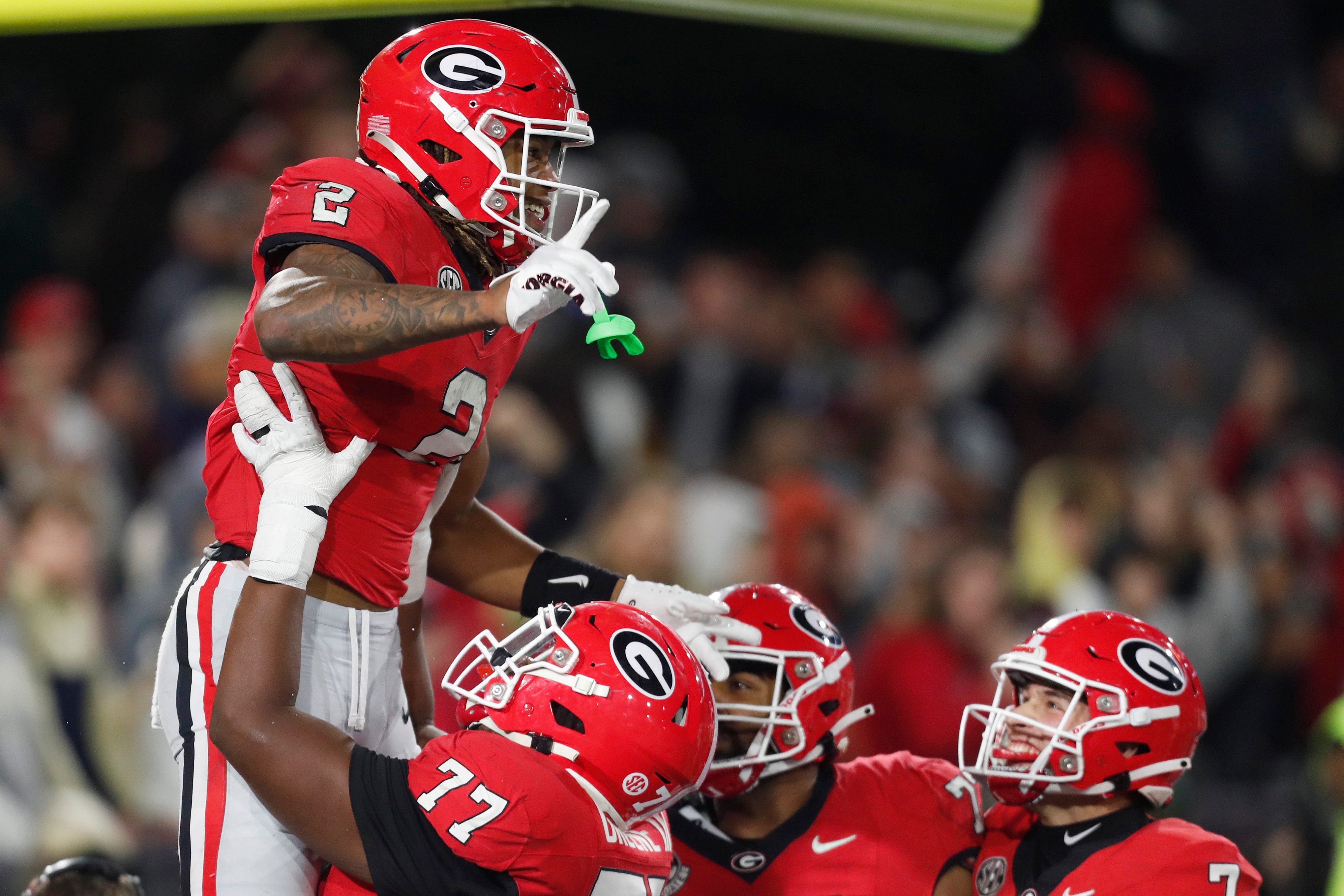 Georgia running back Kendall Milton (2) celebrates with his teammates after scoring a touchdown during the second half of a NCAA college football game against Georgia Tech in Atlanta, on Saturday, Nov.