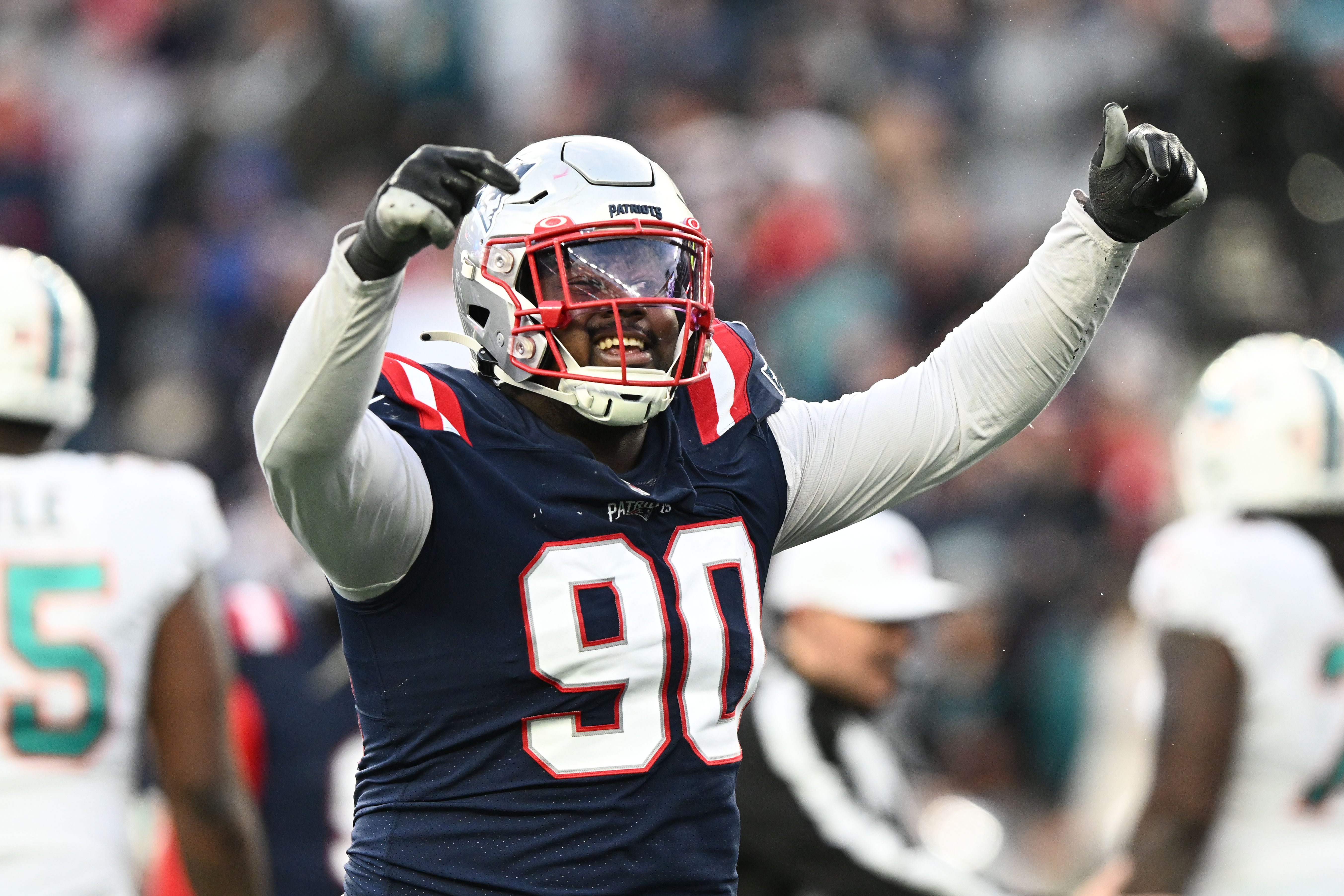 Jan 1, 2023; Foxborough, Massachusetts, USA; New England Patriots defensive tackle Christian Barmore (90) reacts after a sack against the Miami Dolphins during the second half at Gillette Stadium.