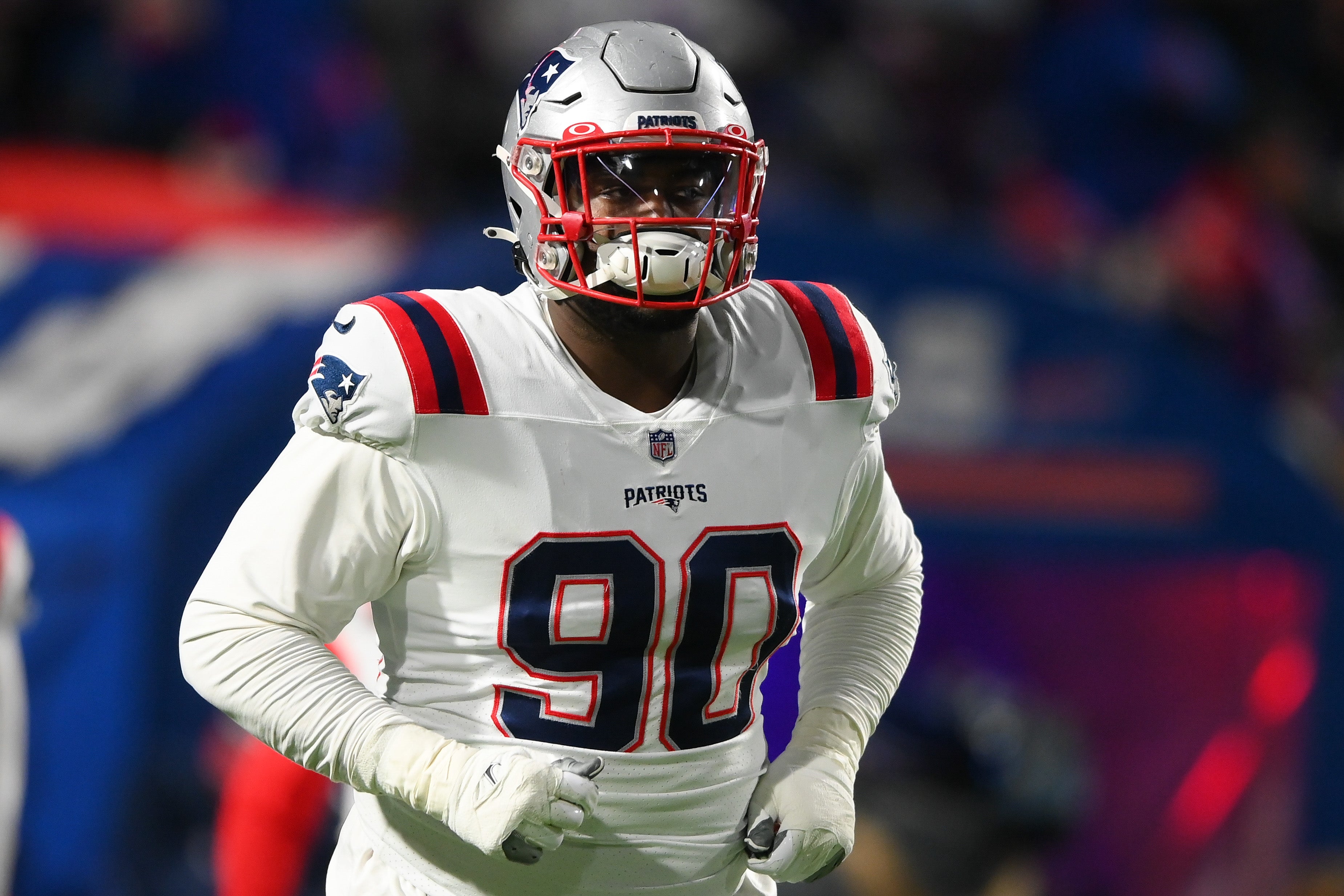 Jan 15, 2022; Orchard Park, New York, USA; New England Patriots defensive end Christian Barmore (90) jogs on the field prior to an AFC Wild Card playoff football game against the Buffalo Bills at Highmark Stadium.