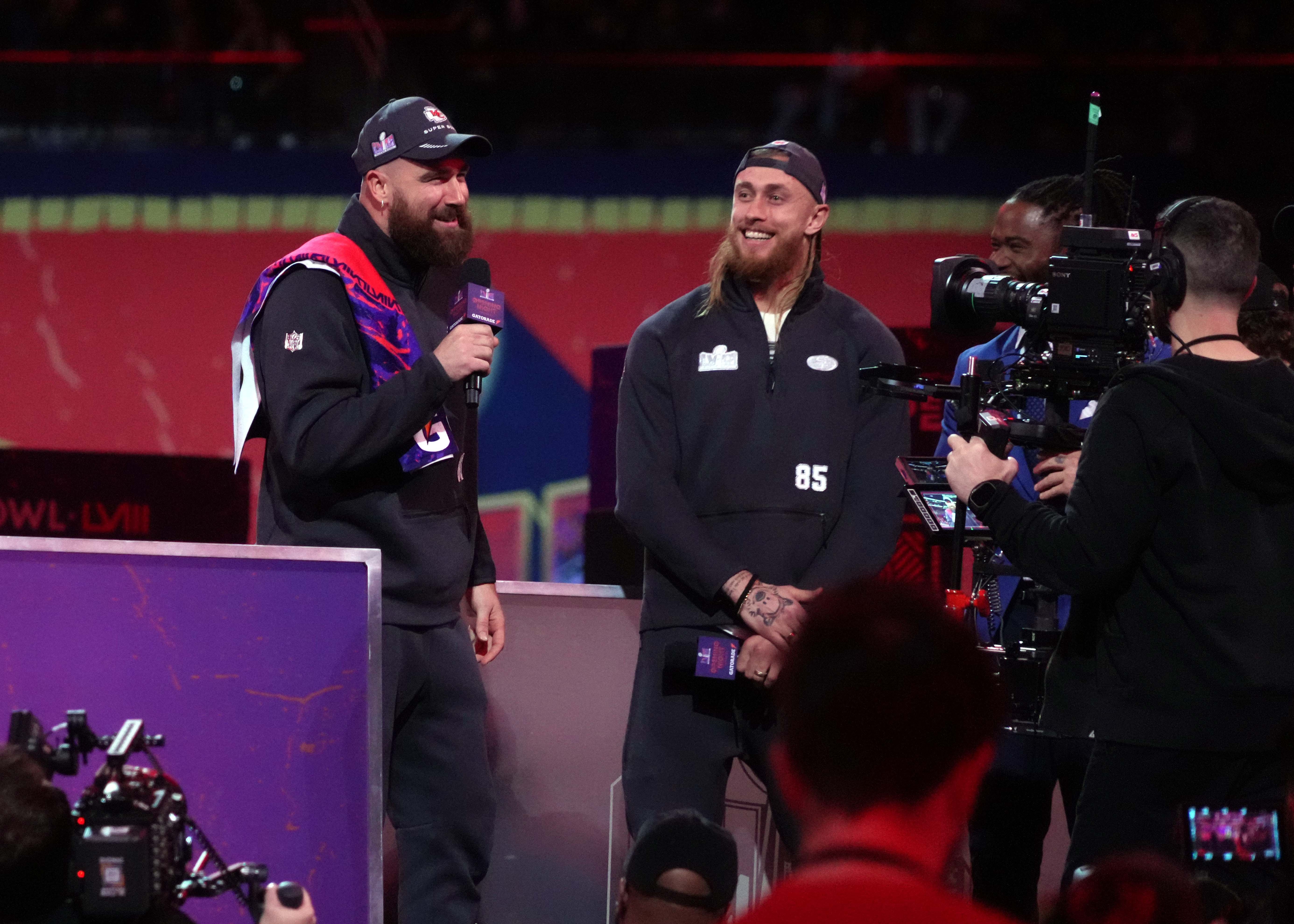 Feb 5, 2024; Las Vegas, NV, USA; Kansas City Chiefs tight end Travis Kelce (87) and San Francisco 49ers tight end George Kittle (85) on stage together during Super Bowl LVIII Opening Night at Allegiant Stadium. Mandatory Credit: