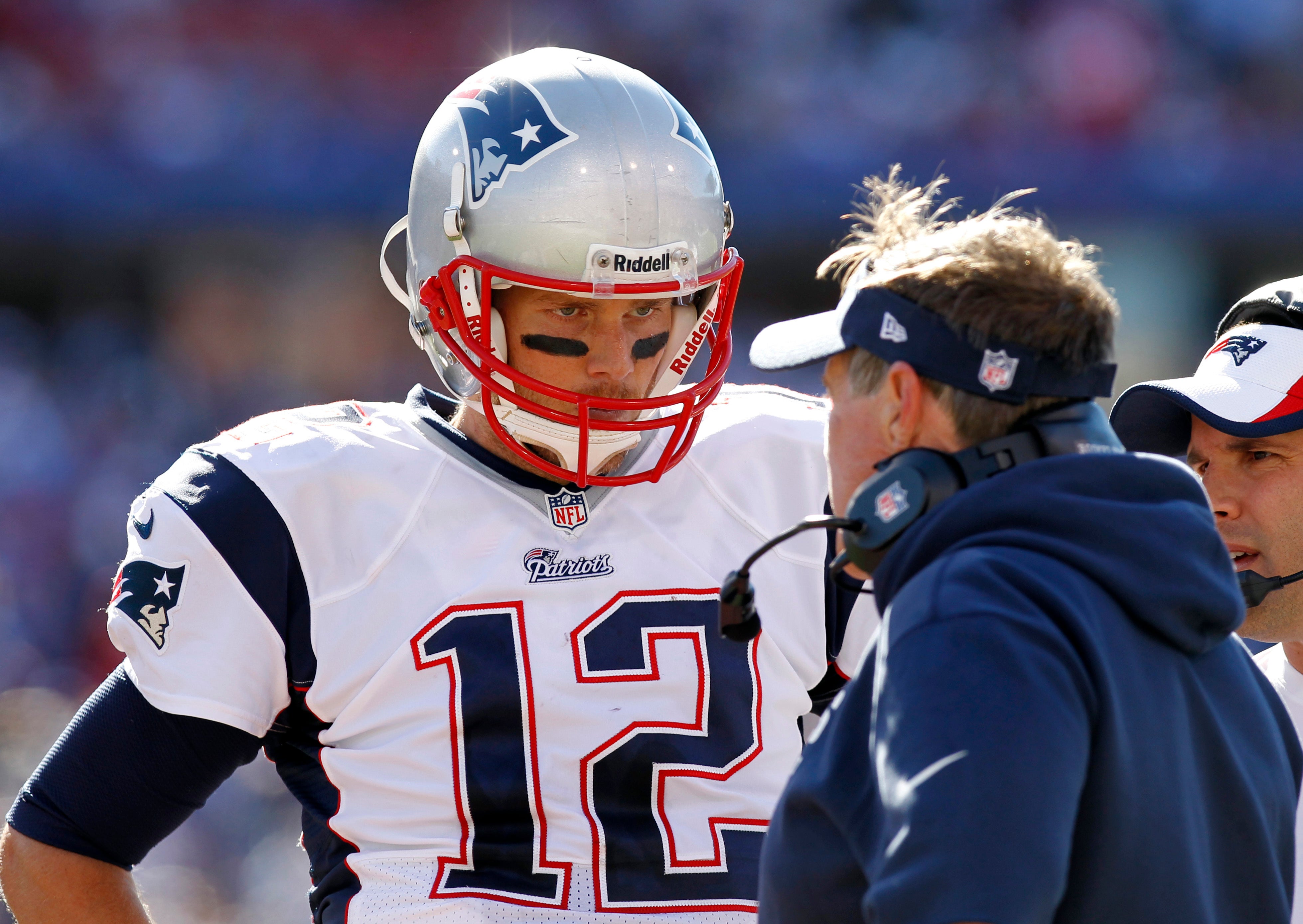 Sep 8, 2013; Orchard Park, NY, USA; New England Patriots quarterback Tom Brady (12) talks with head coach Bill Belichick late in the fourth quarter against the Buffalo Bills at Ralph Wilson Stadium. Patriots beat the Bills 23-21.