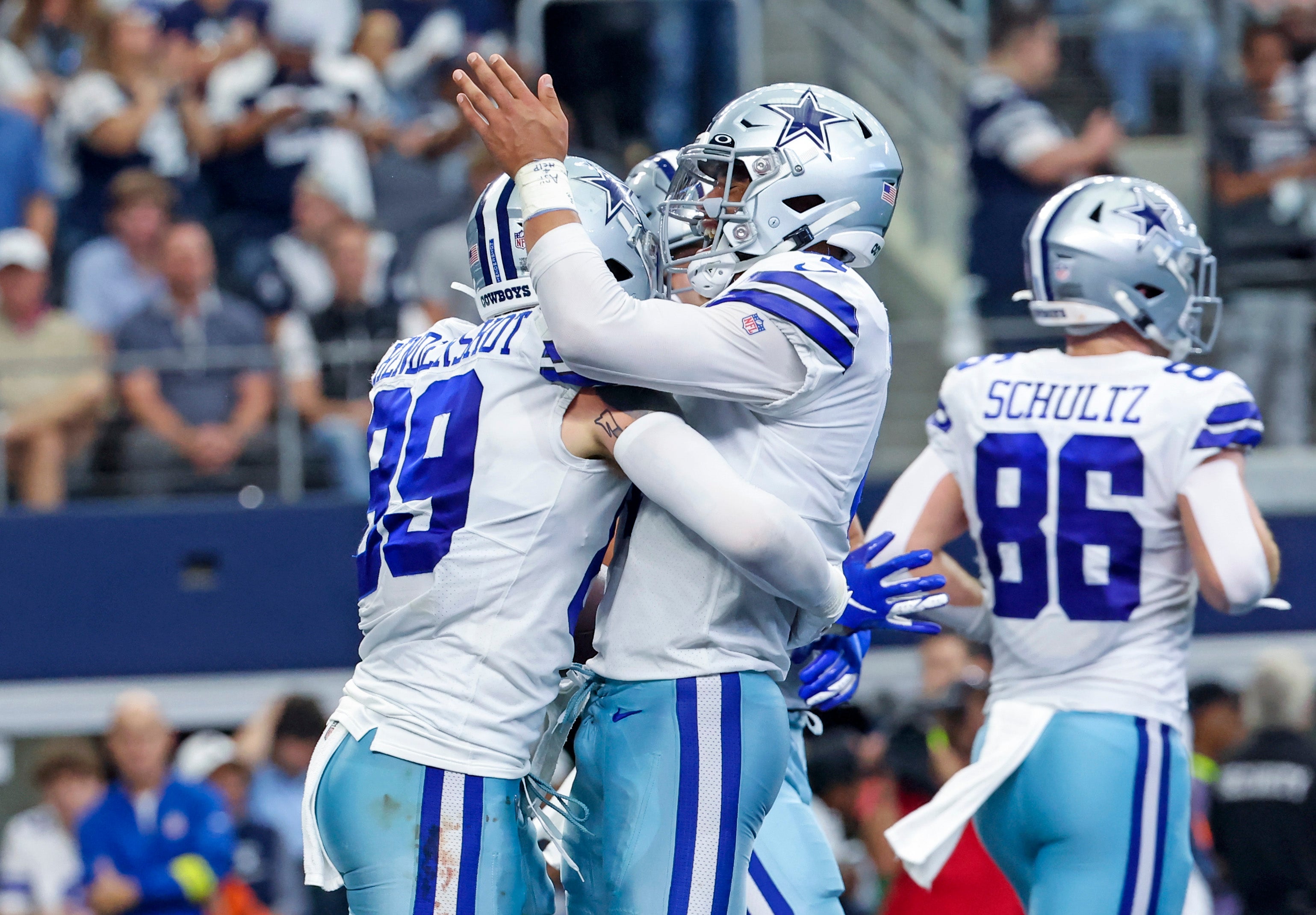 Dallas Cowboys tight end Peyton Hendershot (89) celebrates with quarterback Dak Prescott (4) after catching a touchdown pass during the fourth quarter against the Detroit Lions at AT&T Stadium.
