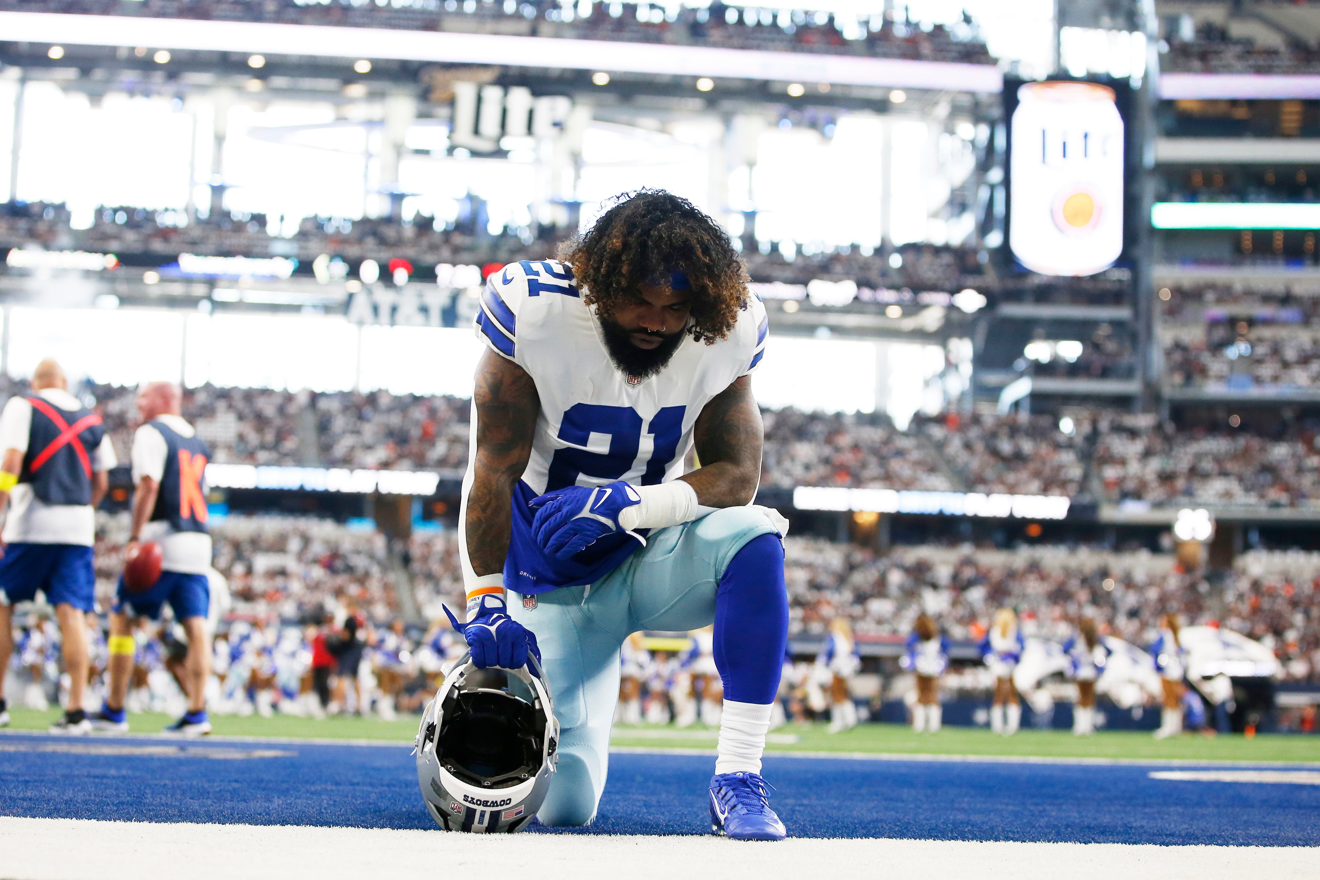 Dallas Cowboys running back Ezekiel Elliott (21) kneels in the end zone before the game against the Cincinnati Bengals at AT&T Stadium.
