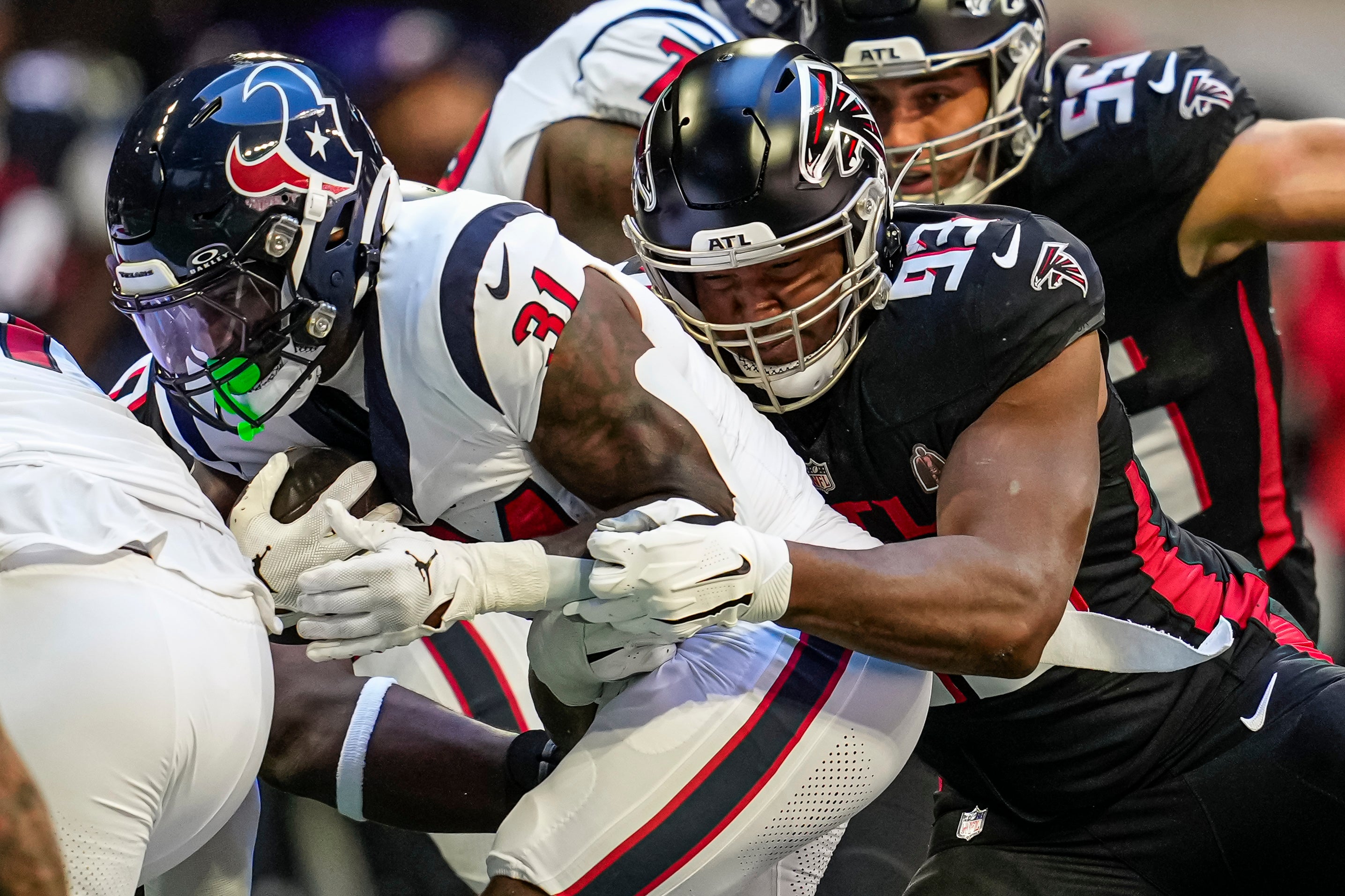 Oct 8, 2023; Atlanta, Georgia, USA; Atlanta Falcons defensive tackle Calais Campbell (93) tackles Houston Texans running back Dameon Pierce (31) during the first quarter at Mercedes-Benz Stadium.