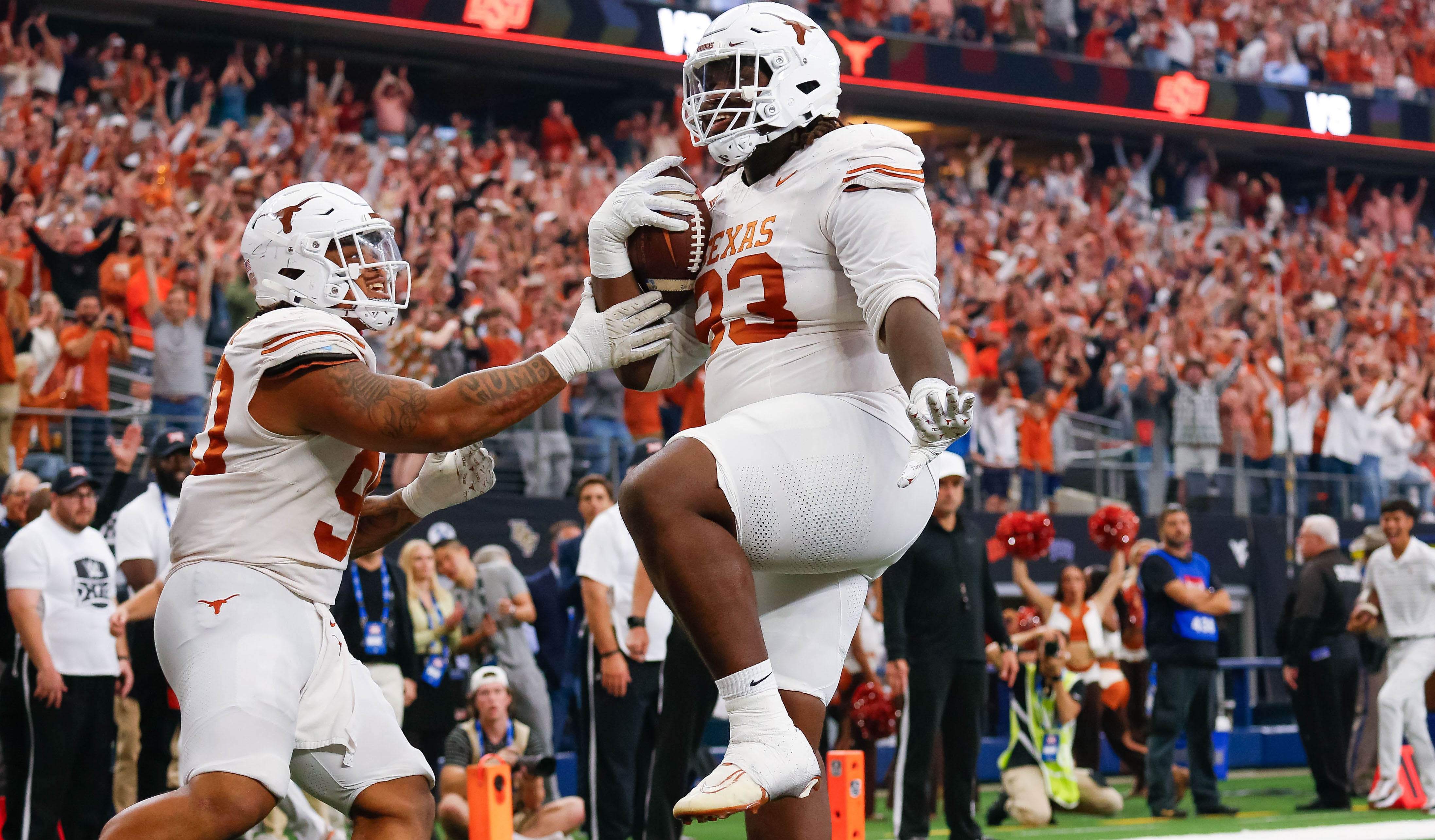 Texas Longhorns defensive lineman T'Vondre Sweat (93) celebrates his touchdown catch with teammate defensive lineman Byron Murphy II (90) during the first quarter at AT&T Stadium. Andrew Dieb-USA TODAY Sports