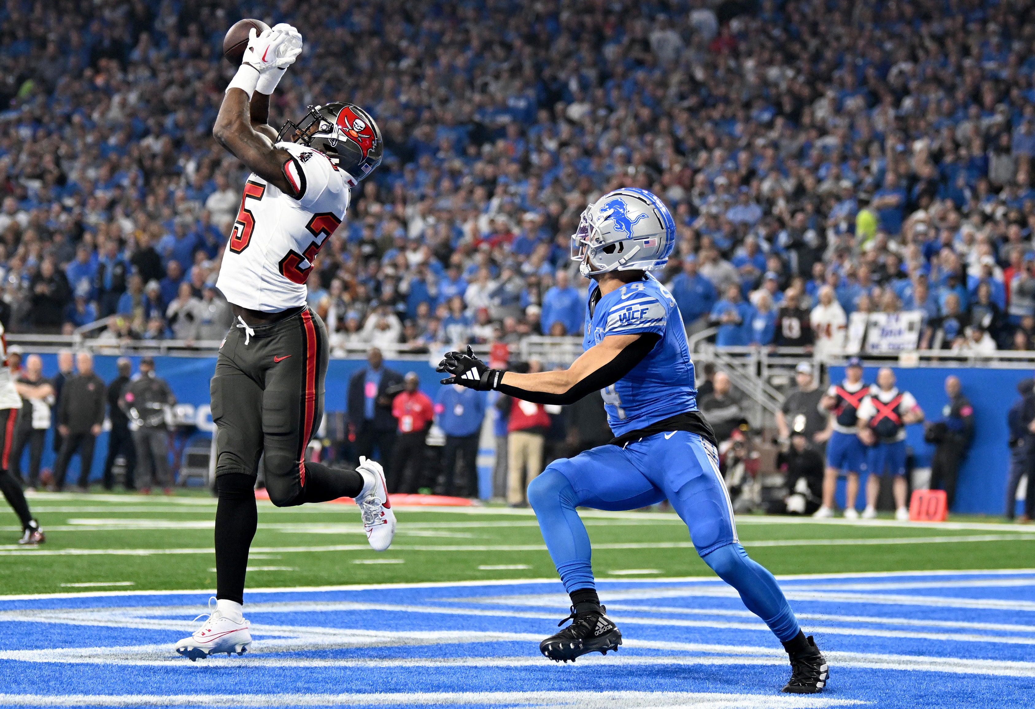 Jan 21, 2024; Detroit, Michigan, USA; Tampa Bay Buccaneers cornerback Jamel Dean (35) breaks up a pass intended for Detroit Lions wide receiver Amon-Ra St. Brown (14) during the first quarter in a 2024 NFC divisional round game at Ford Field.