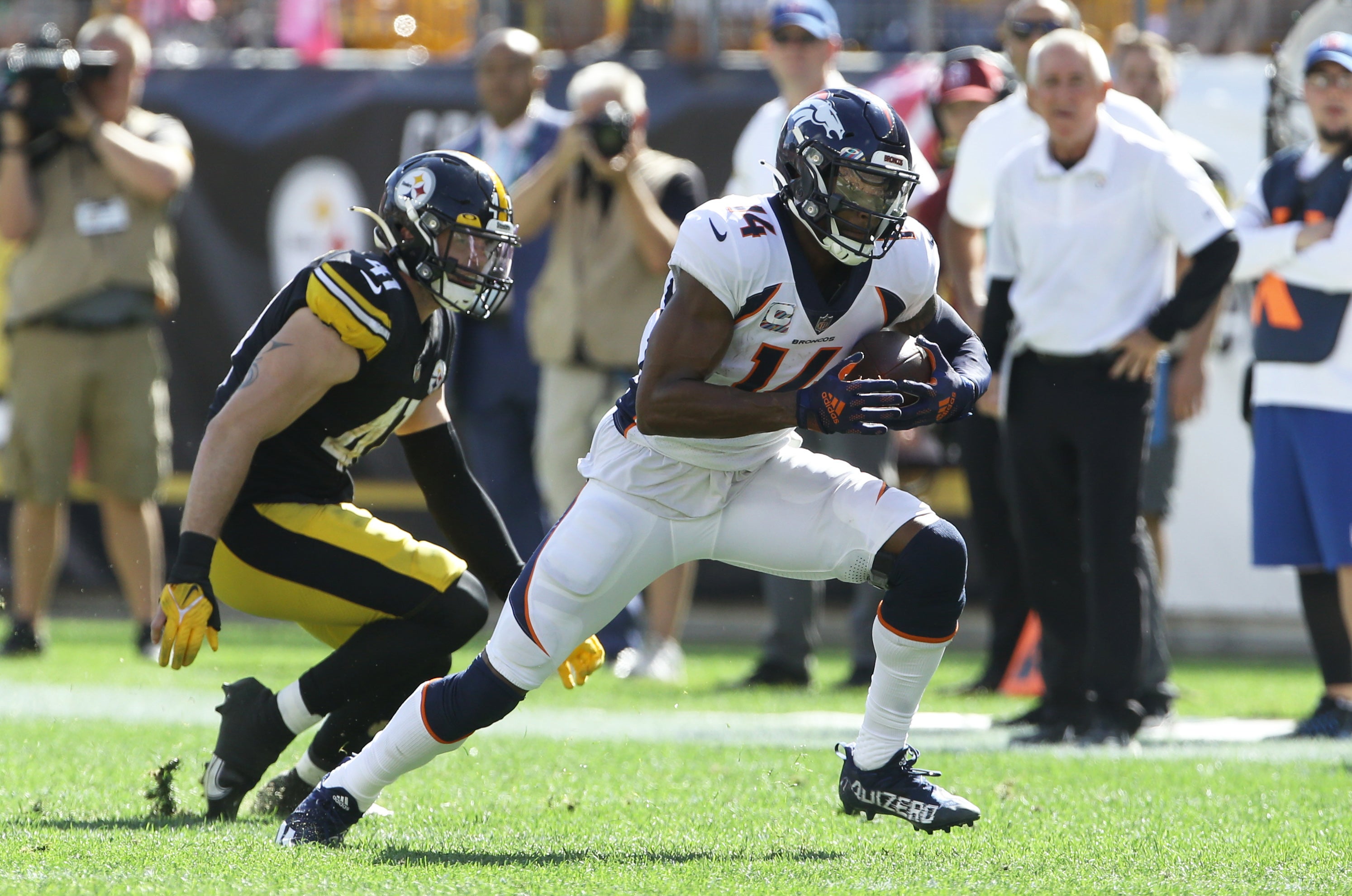 Oct 10, 2021; Pittsburgh, Pennsylvania, USA; Denver Broncos wide receiver Courtland Sutton (14) runs after a catch as Pittsburgh Steelers inside linebacker Robert Spillane (41) defends during the second quarter at Heinz Field. Mandatory Credit: Charles LeClaire-USA TODAY Sports