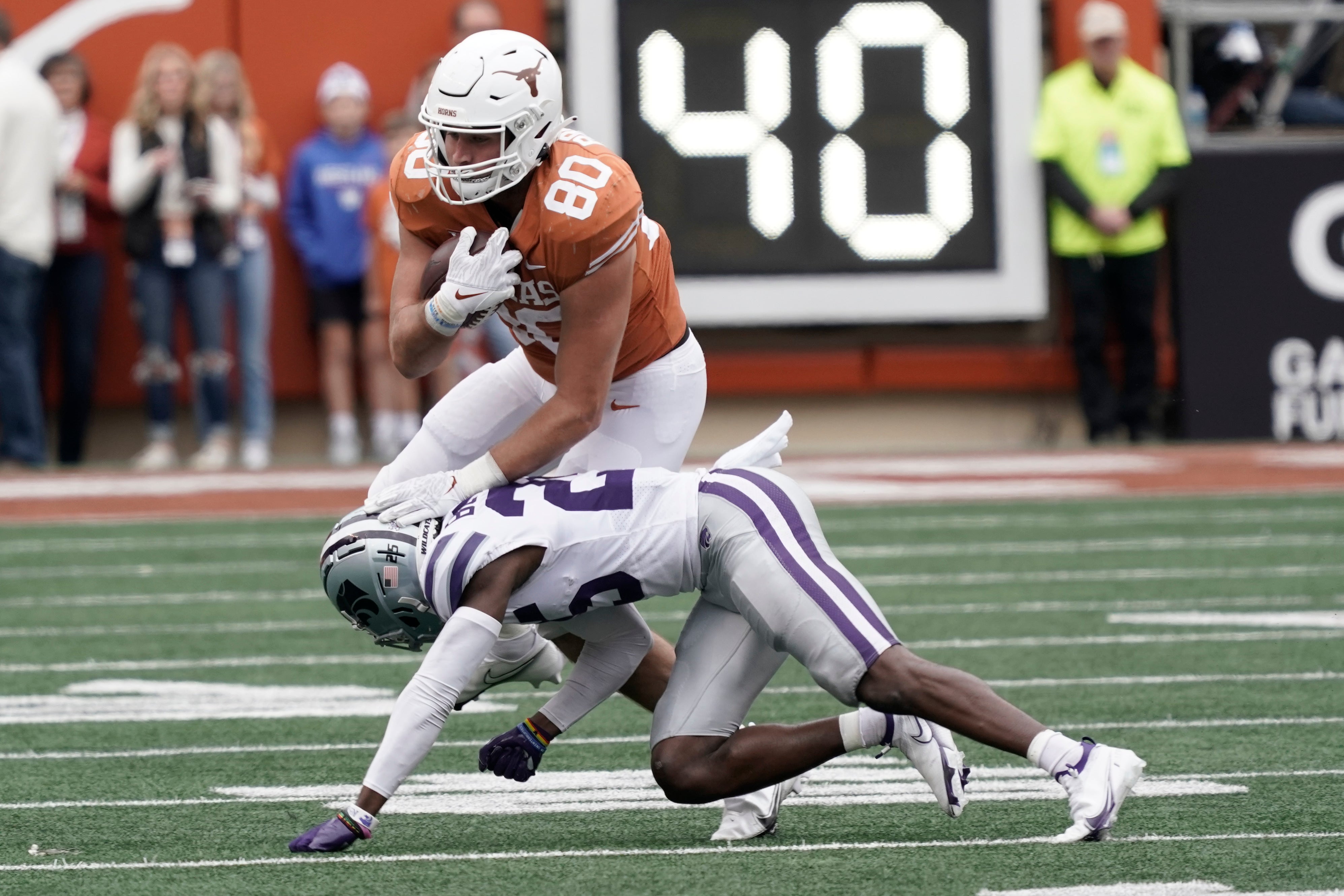 Nov 26, 2021; Austin, Texas, USA; Texas Longhorns tight end Cade Brewer (80) is tackled by Kansas State Wildcats defensive back Ekow Boye-Doe (25) after taking a catch in the second half at Darrell K Royal-Texas Memorial Stadium.
