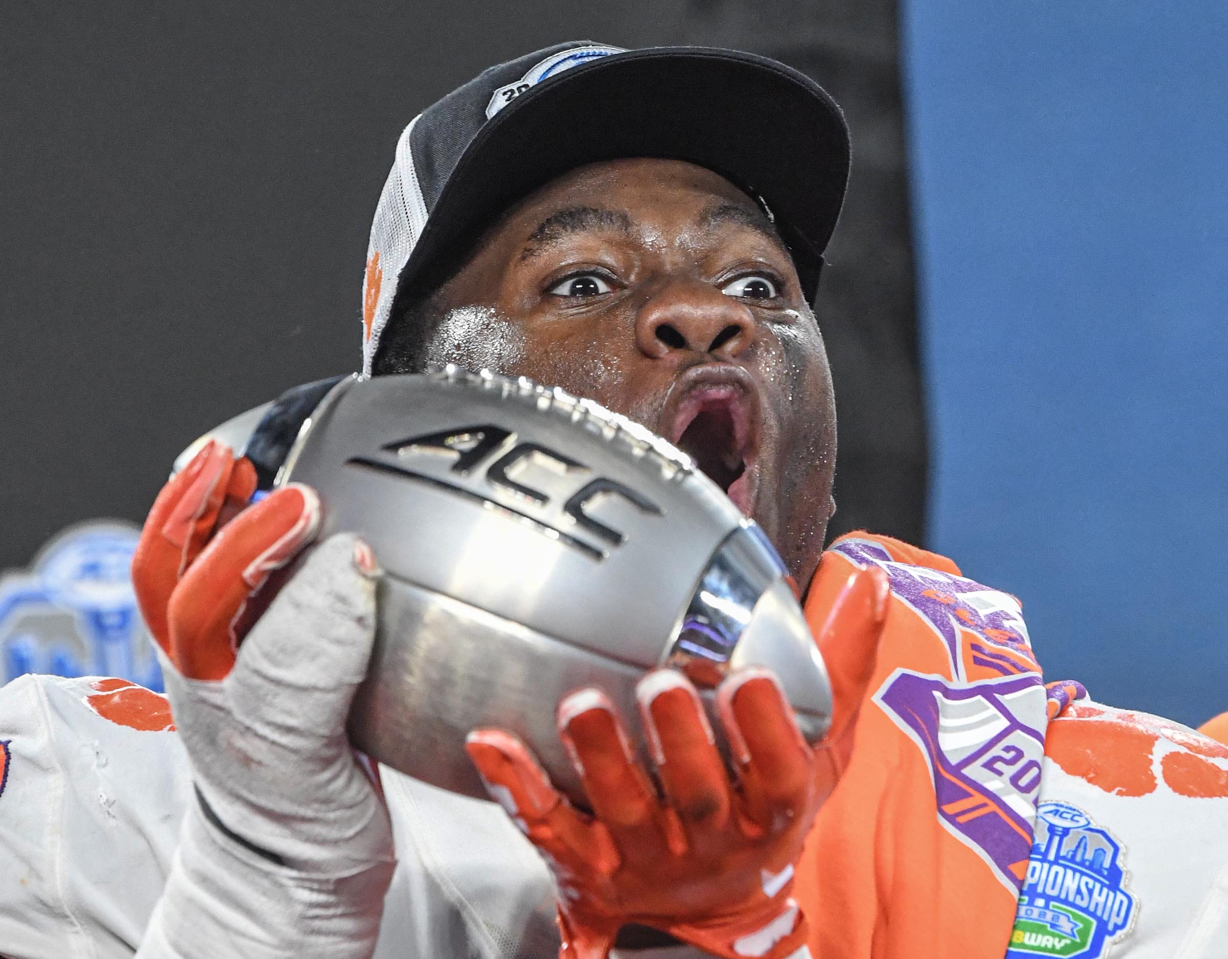 Clemson defensive tackle Ruke Orhorhoro (33) raises the ACC Championship trophy near team players after the game over North Carolina in the ACC Championship football game at Bank of America Stadium.
