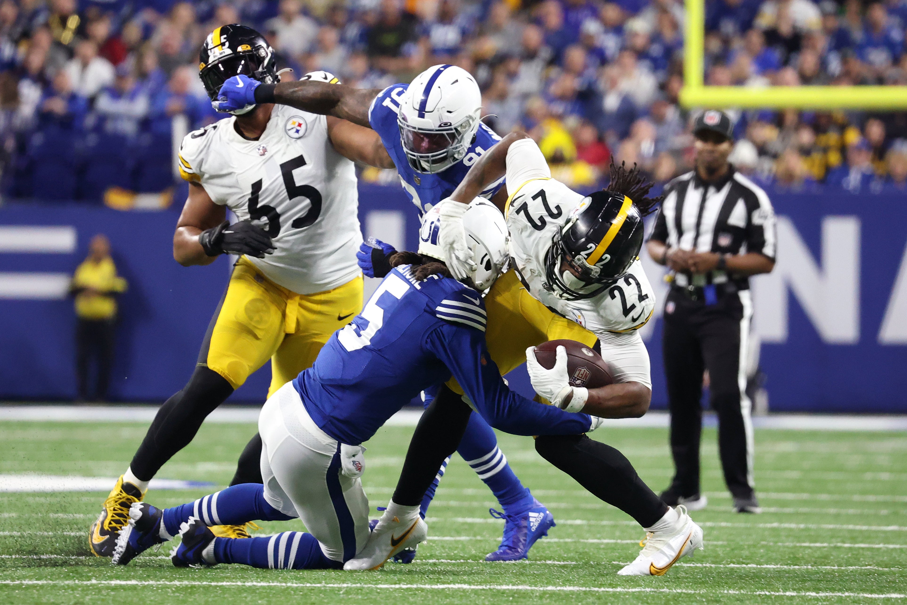 Nov 28, 2022; Indianapolis, Indiana, USA; Pittsburgh Steelers running back Najee Harris (22) is tackled by Indianapolis Colts cornerback Stephon Gilmore (5) during the first half at Lucas Oil Stadium. Mandatory Credit: Trevor Ruszkowski-USA TODAY Sports