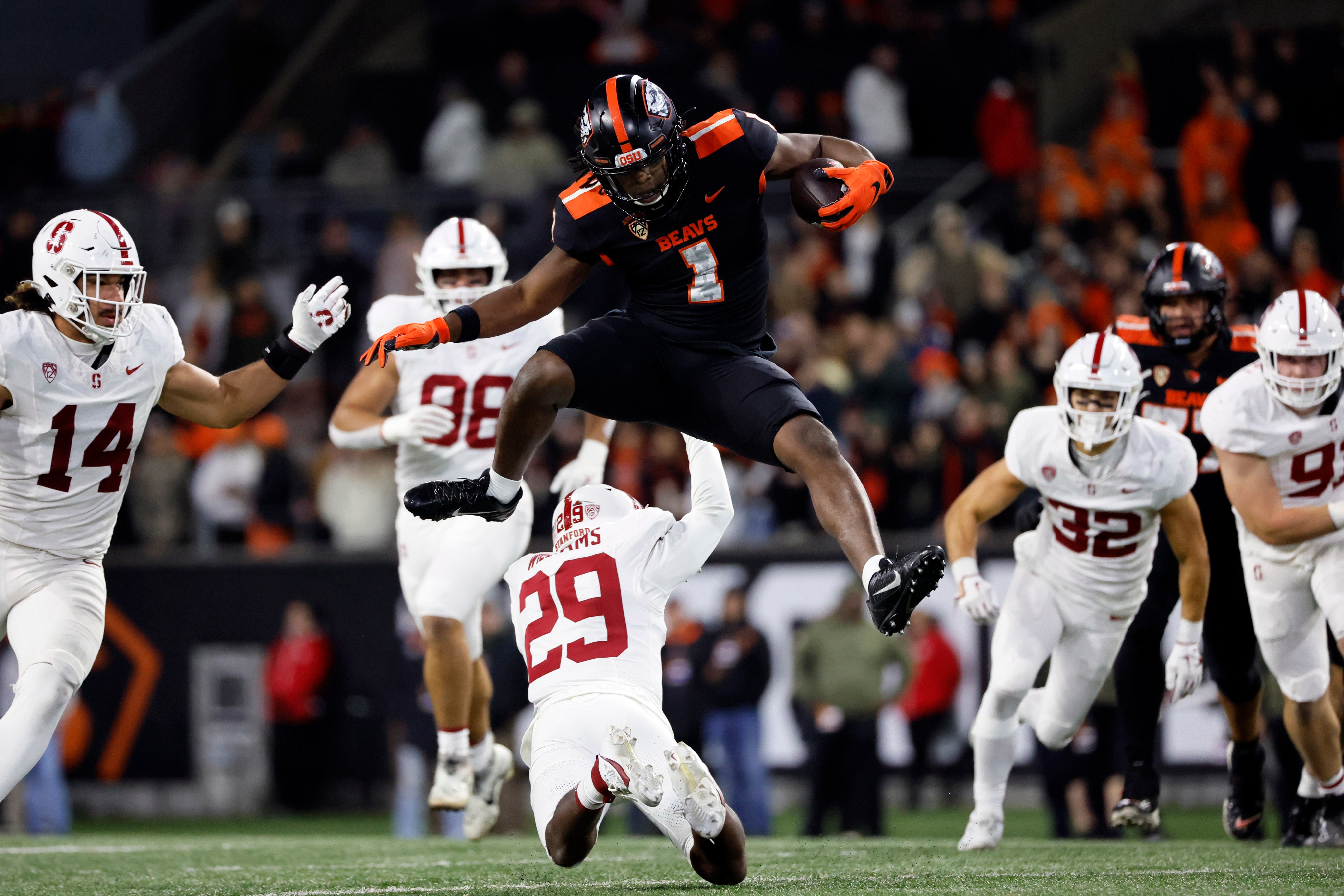 Nov 11, 2023; Corvallis, Oregon, USA; Oregon State Beavers running back Deshaun Fenwick (1) jumps over Stanford Cardinal corner back Terian Williams (29) during the second half at Reser Stadium.
