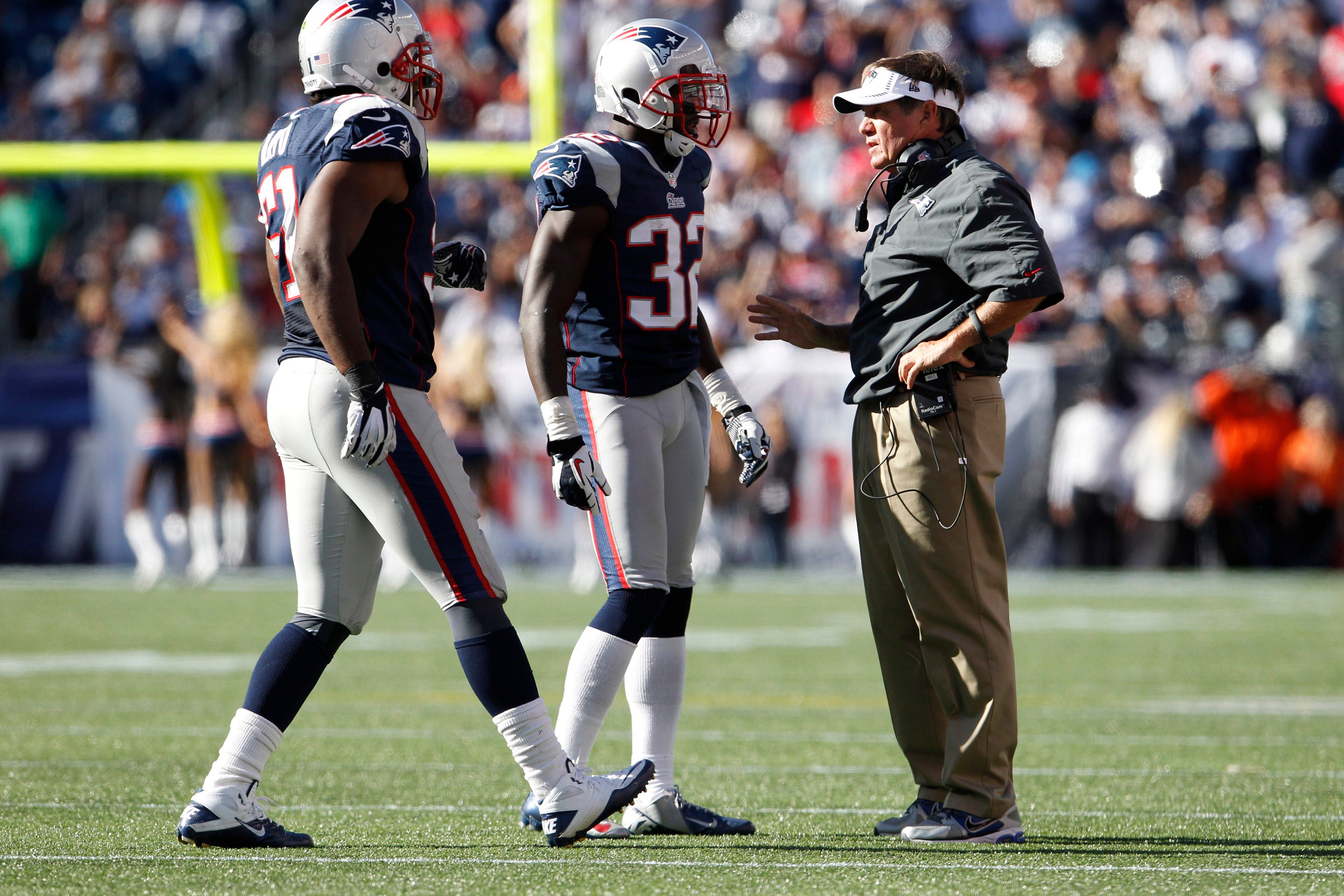 Sep 16, 2012; Foxborough, MA, USA; New England Patriots head coach Bill Belichick talks with cornerback Devin McCourty (32) and outside linebacker Jerod Mayo (51) as they take on the Arizona Cardinals during the second half at Gillette Stadium. The Arizona Cardinals defeated the New England Patriots 20-18.