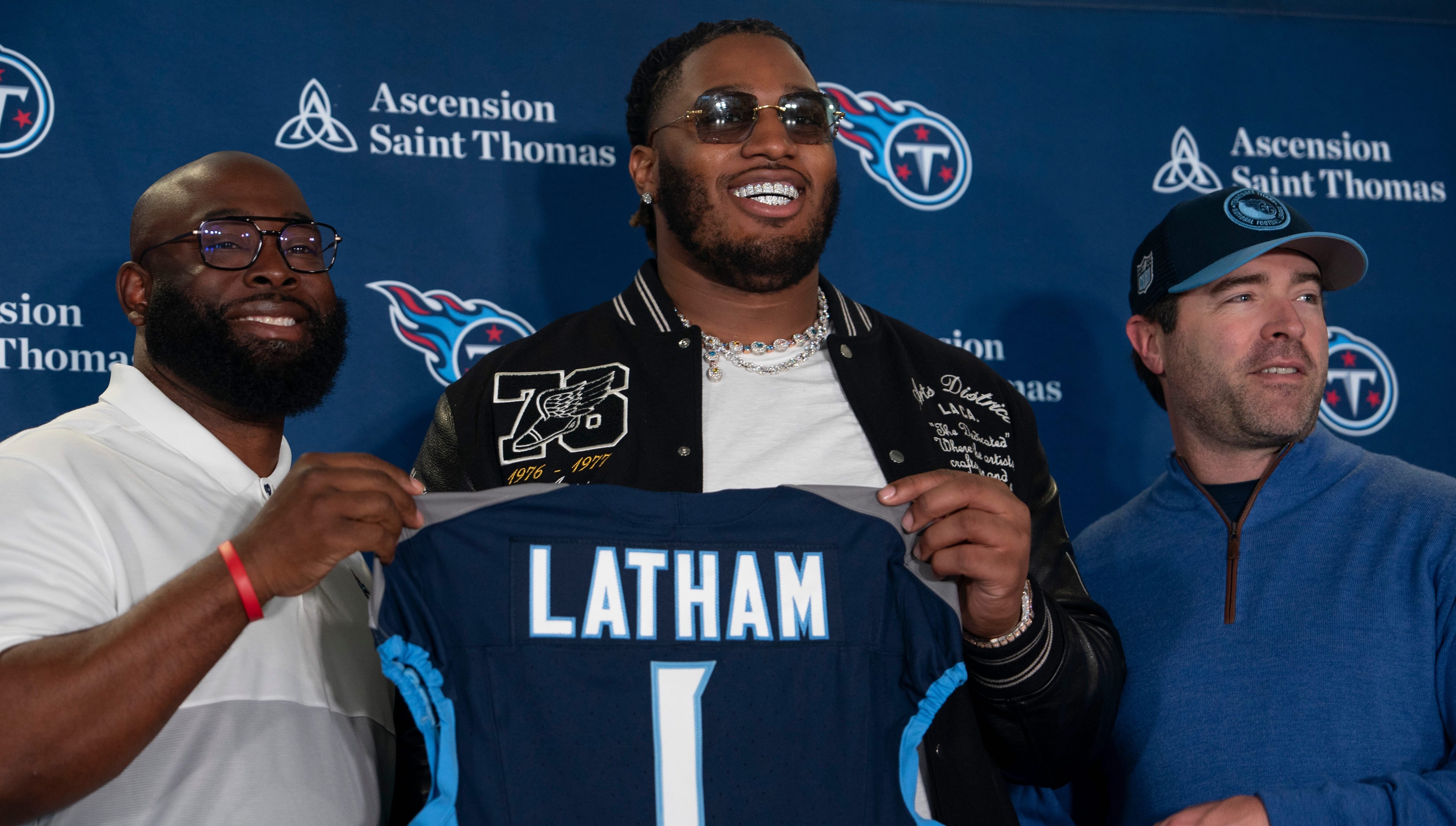 The Tennessee Titans first-round draft pick JC Latham poses with his new Titans jersey and General Manager Ran Carthon, left, and Head Coach Brian Callahan, right, at the teams Ascension Saint Thomas ... Denny Simmons / The Tennessean-USA TODAY NETWORK