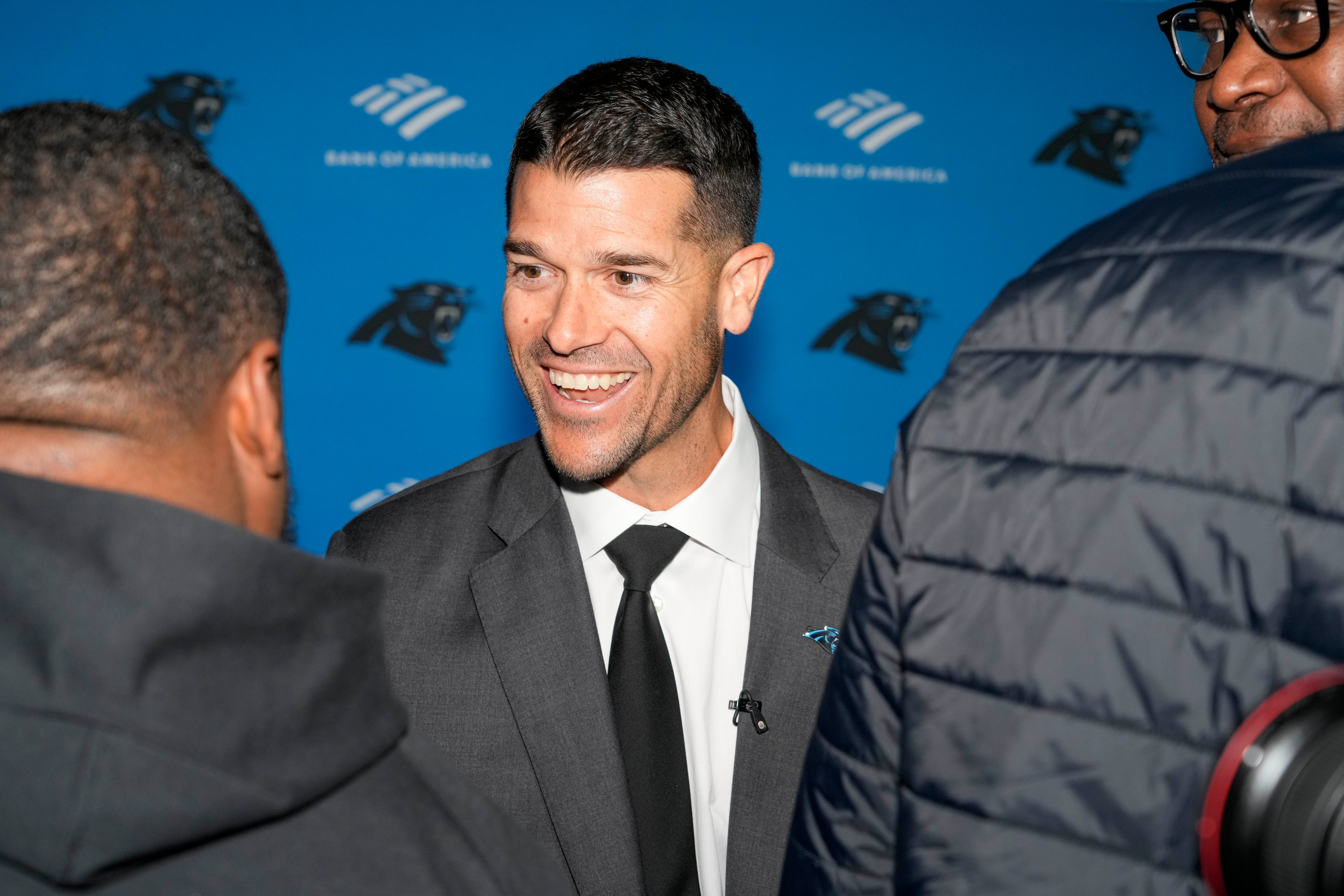 Feb 1, 2024; Charlotte, NC, USA; Carolina Panthers head coach Dave Canales greets former player Dave Tolbert at Bank of America Stadium. Mandatory Credit: Jim Dedmon-USA TODAY Sports