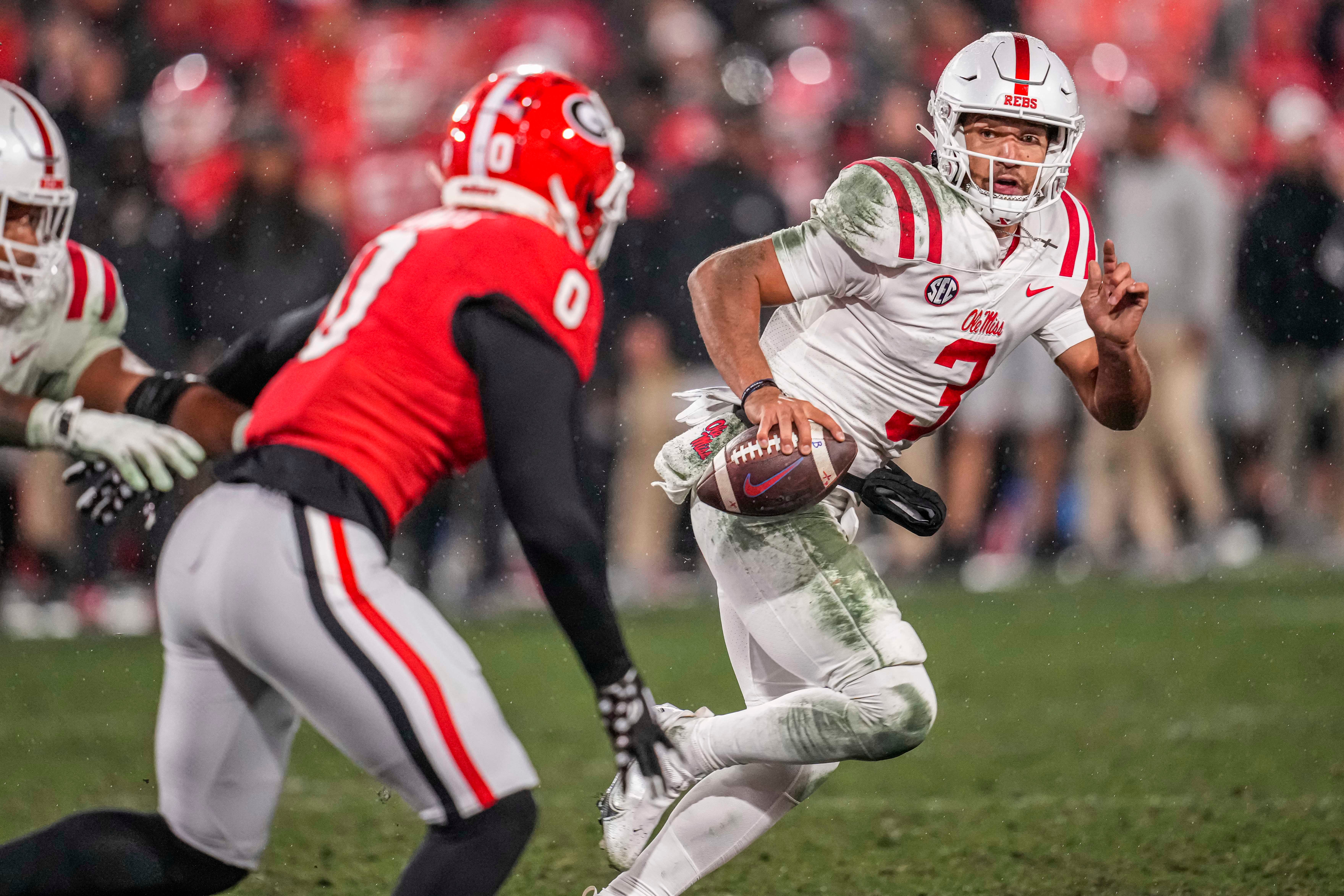 Nov 11, 2023; Athens, Georgia, USA; A Mississippi Rebels quarterback Spencer Sanders (3) tries to escape the pressure from Georgia Bulldogs linebacker Troy Bowles (0) during the second half at Sanford Stadium.