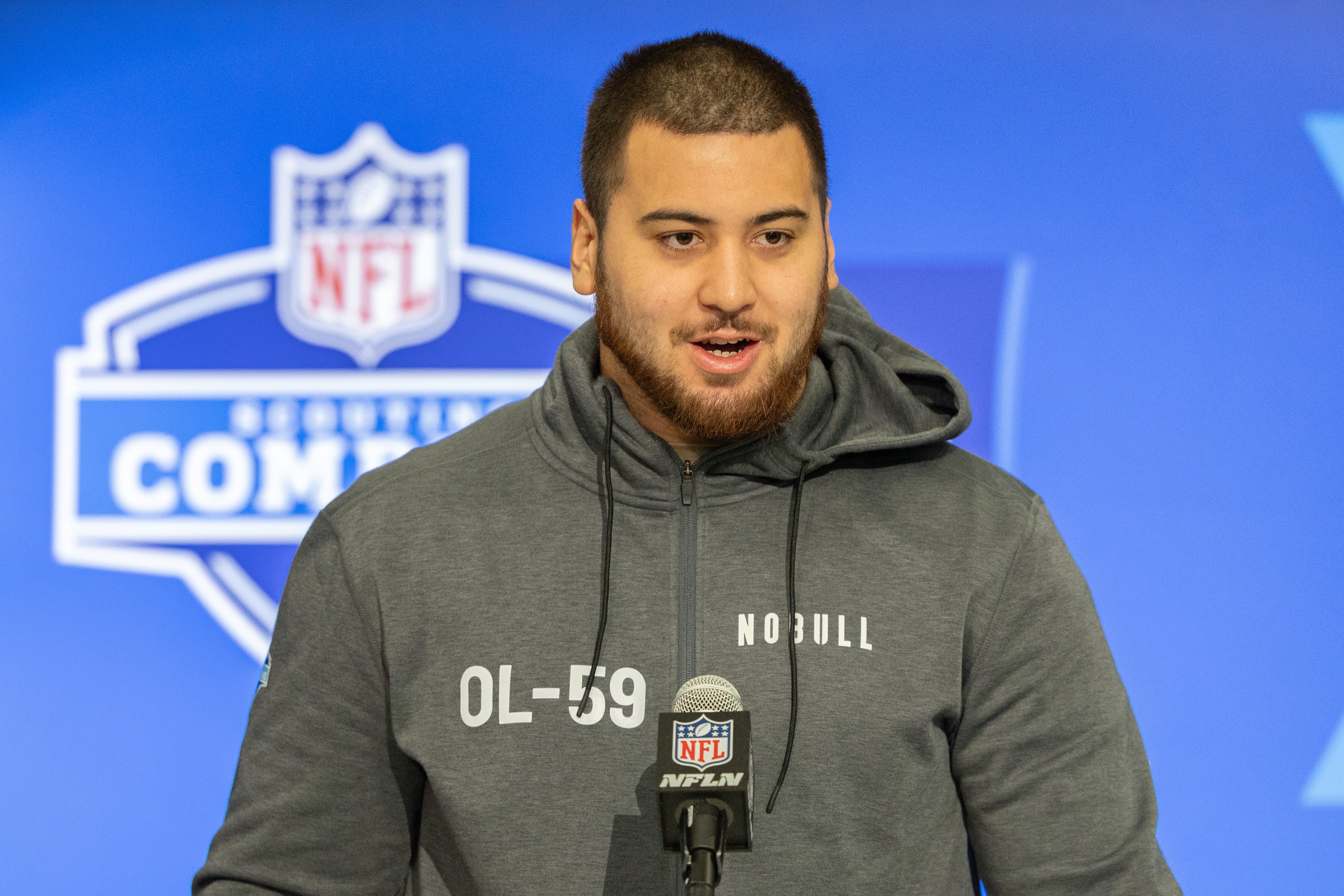 Mar 2, 2024; Indianapolis, IN, USA; Kansas offensive lineman Dominick Puni (OL59) talks to the media during the 2024 NFL Combine at Lucas Oil Stadium.