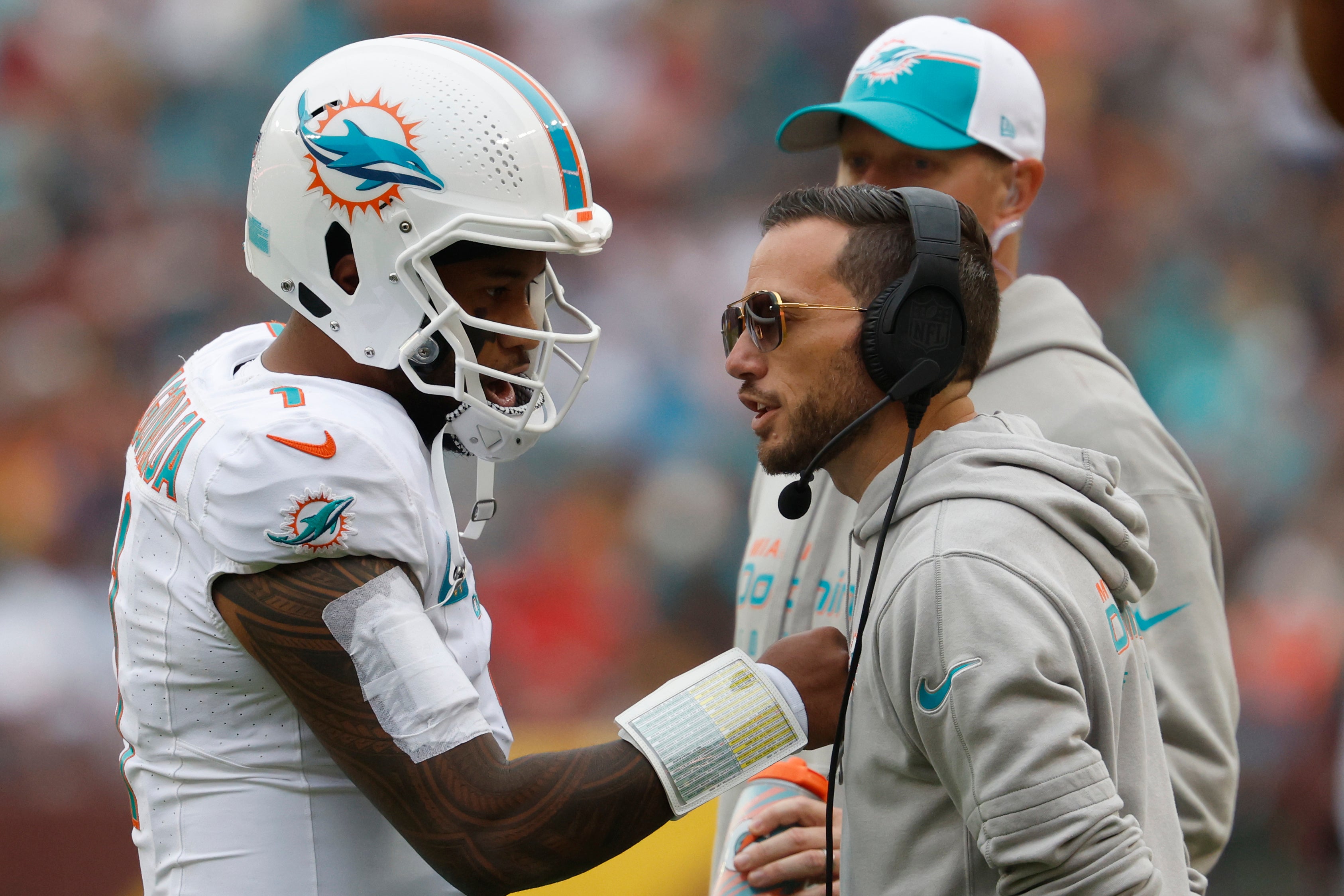 Dec 3, 2023; Landover, Maryland, USA; Miami Dolphins quarterback Tua Tagovailoa (1) talks with Dolphins head coach Mike McDaniel (R) during a timeout against the Washington Commanders during the second quarter at FedExField.