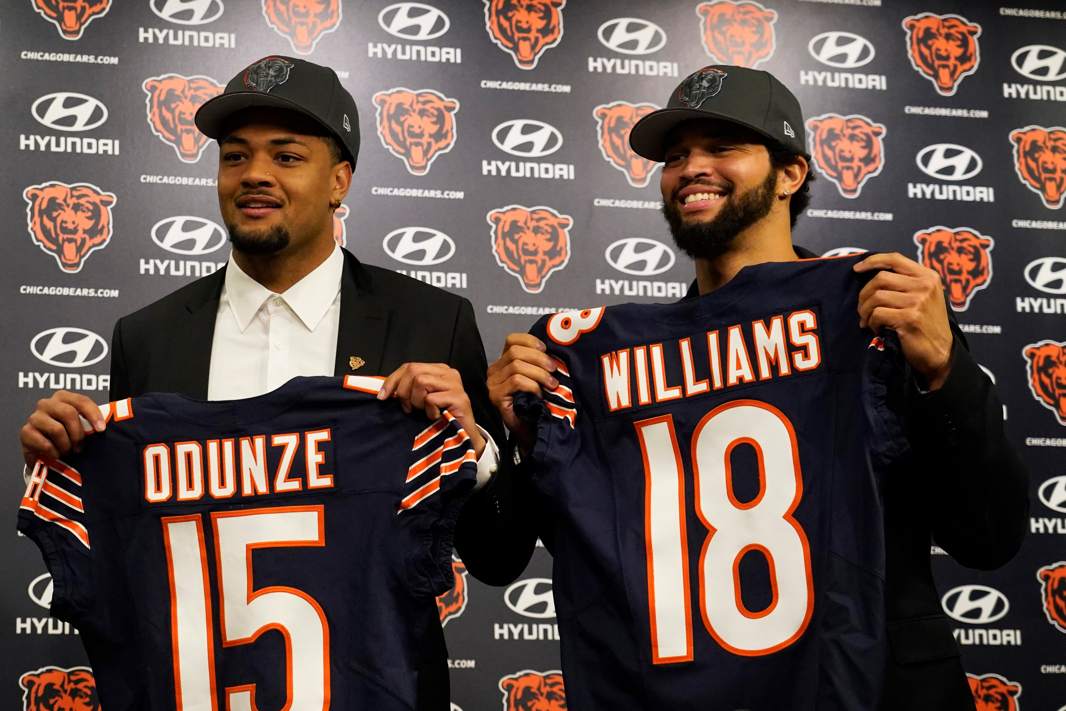 Apr 26, 2024; Lake Forest, IL, USA; Chicago Bears first round draft choices Rome Odunze (left) and Caleb Williams (right) pose for photos at a press conference at Halas Hall.