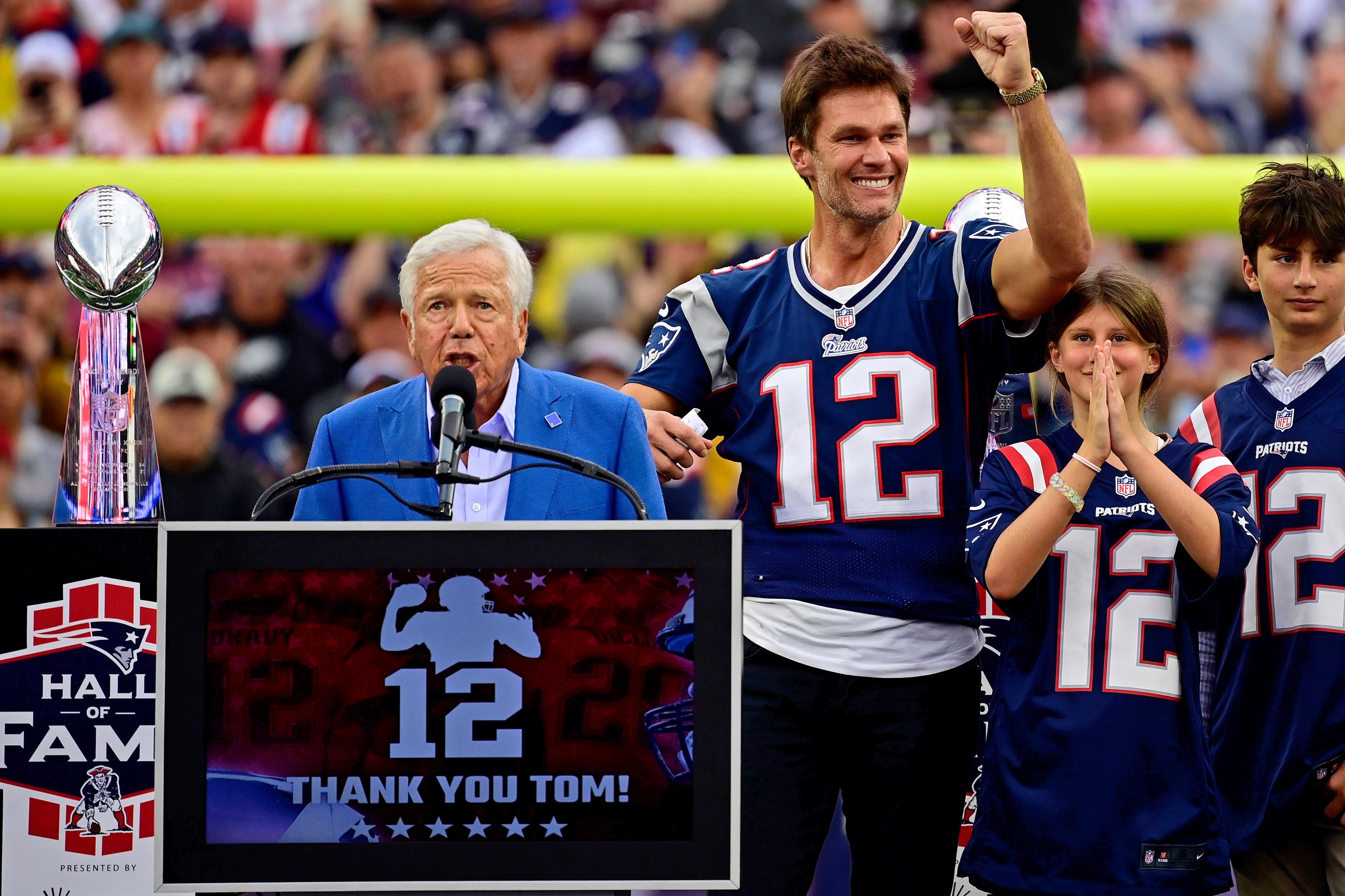Sep 10, 2023; Foxborough, Massachusetts, USA; New England Patriots former quarterback Tom Brady gestures as New England Patriots owner Robert Kraft speaks during a halftime ceremony in his honor during the game between the Philadelphia Eagles and New England Patriots at Gillette Stadium.