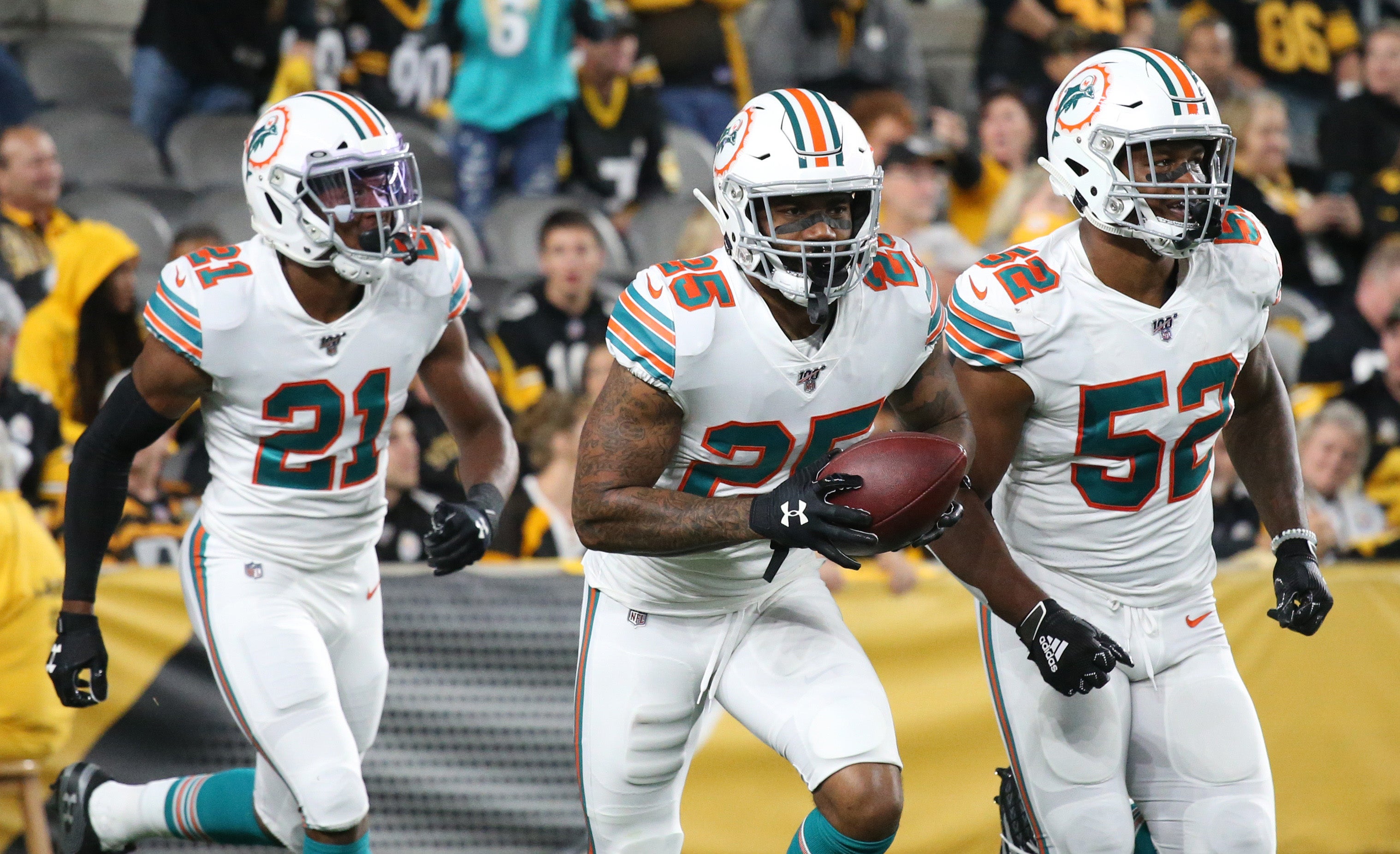 Oct 28, 2019; Pittsburgh, PA, USA; Miami Dolphins cornerback Xavien Howard (25) celebrates his interception with cornerback Eric Rowe (21) and middle linebacker Raekwon McMillan (52) against the Pittsburgh Steelers during the first quarter at Heinz Field. The Steelers won 27-14. Mandatory Credit: Charles LeClaire-USA TODAY Sports  