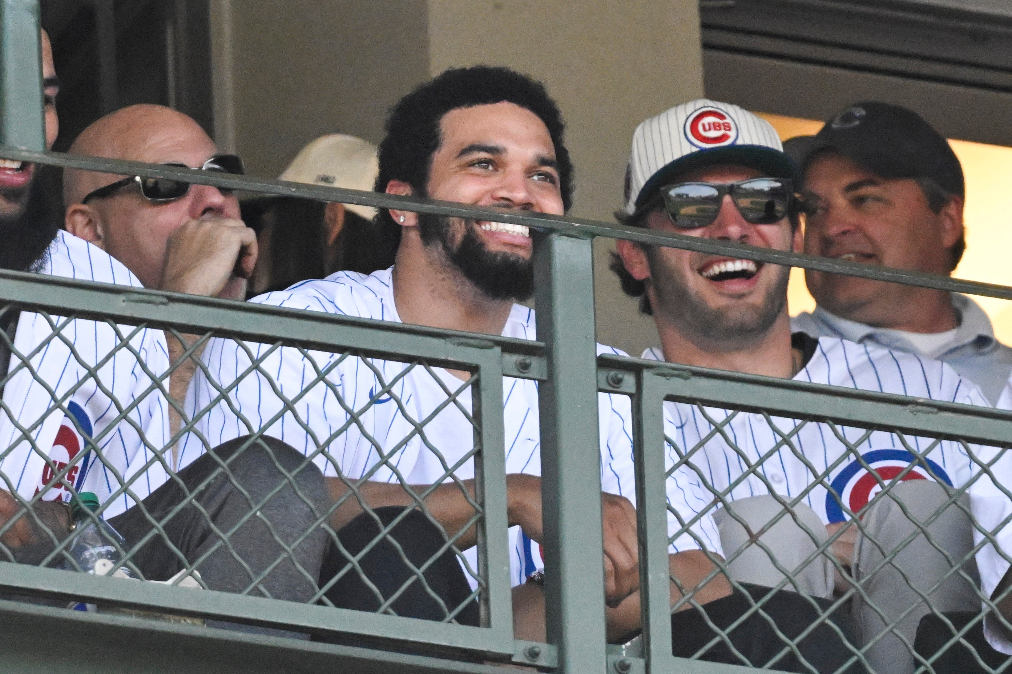 May 4, 2024; Chicago, Illinois, USA; Chicago Bears first round draft pic Caleb Williams (center) looks on during the game between the Chicago Cubs and the Milwaukee Brewers at Wrigley Field.
