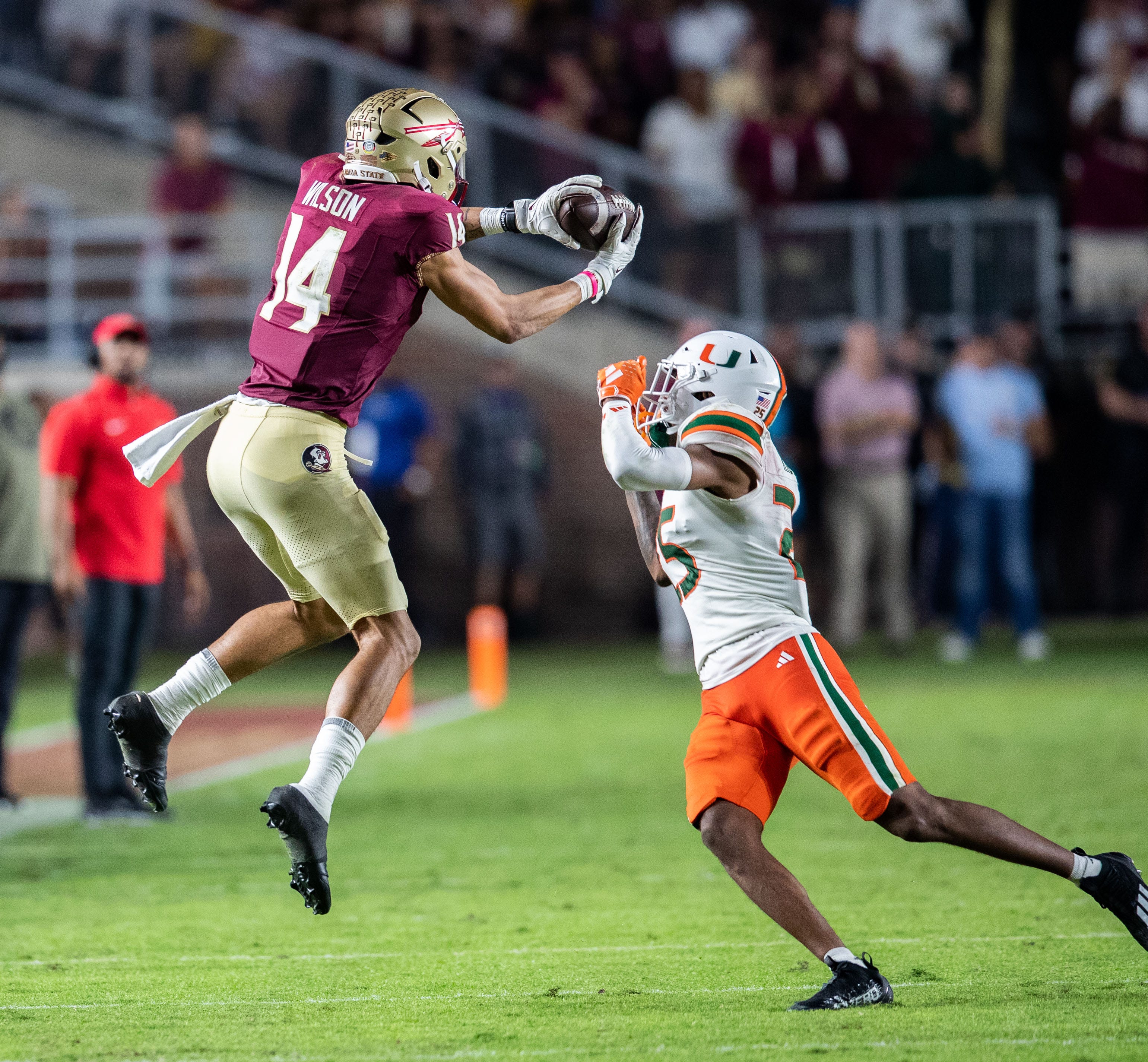 Florida State Seminoles wide receiver Johnny Wilson (14) catches a pass from Florida State Seminoles quarterback Jordan Travis (13). The Florida State Seminoles defeated the Miami Hurricanes 27-20.