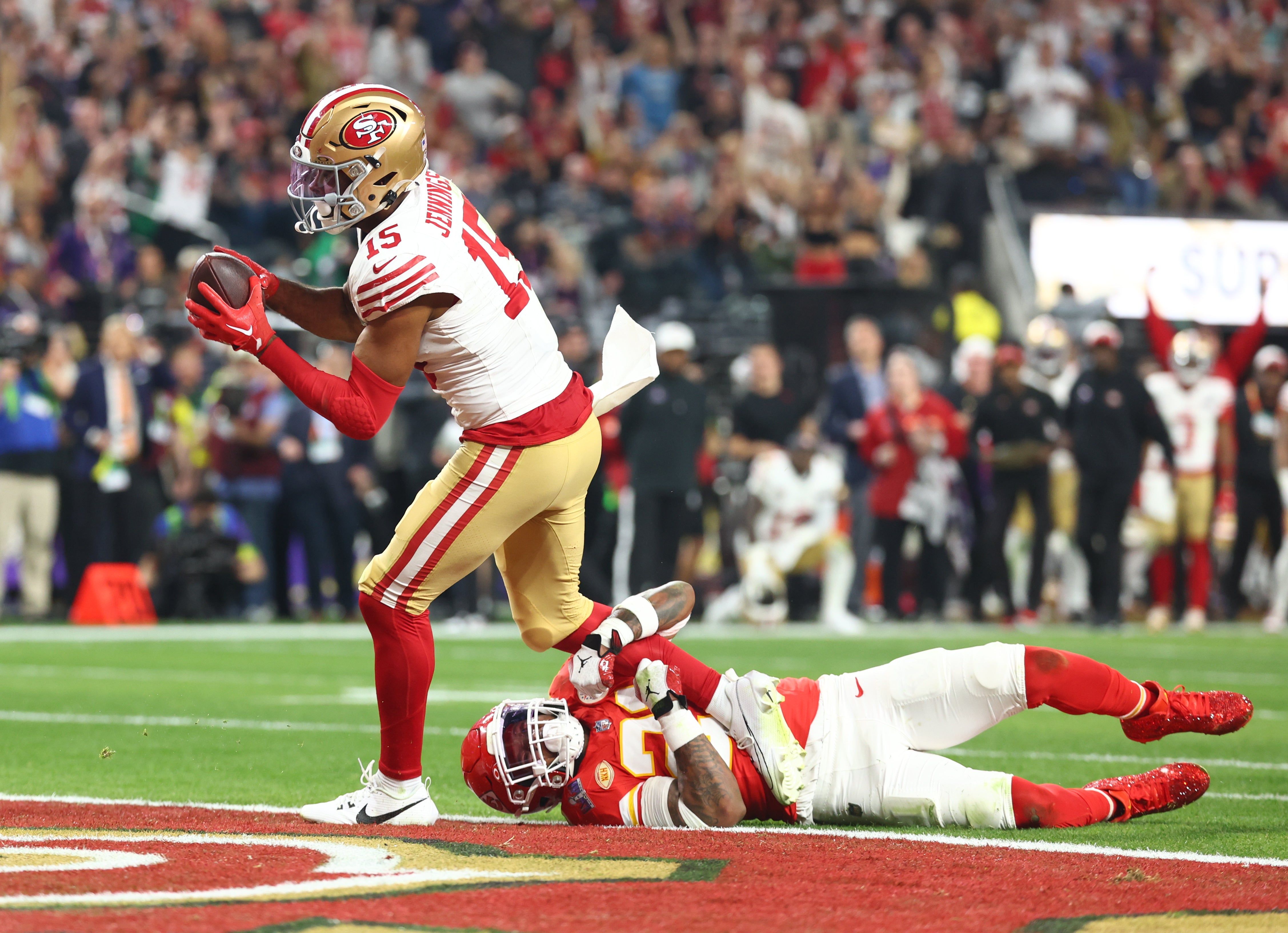 Feb 11, 2024; Paradise, Nevada, USA; San Francisco 49ers wide receiver Jauan Jennings (15) scores a touchdown against Kansas City Chiefs safety Mike Edwards (21) in the second half in Super Bowl LVIII at Allegiant Stadium.