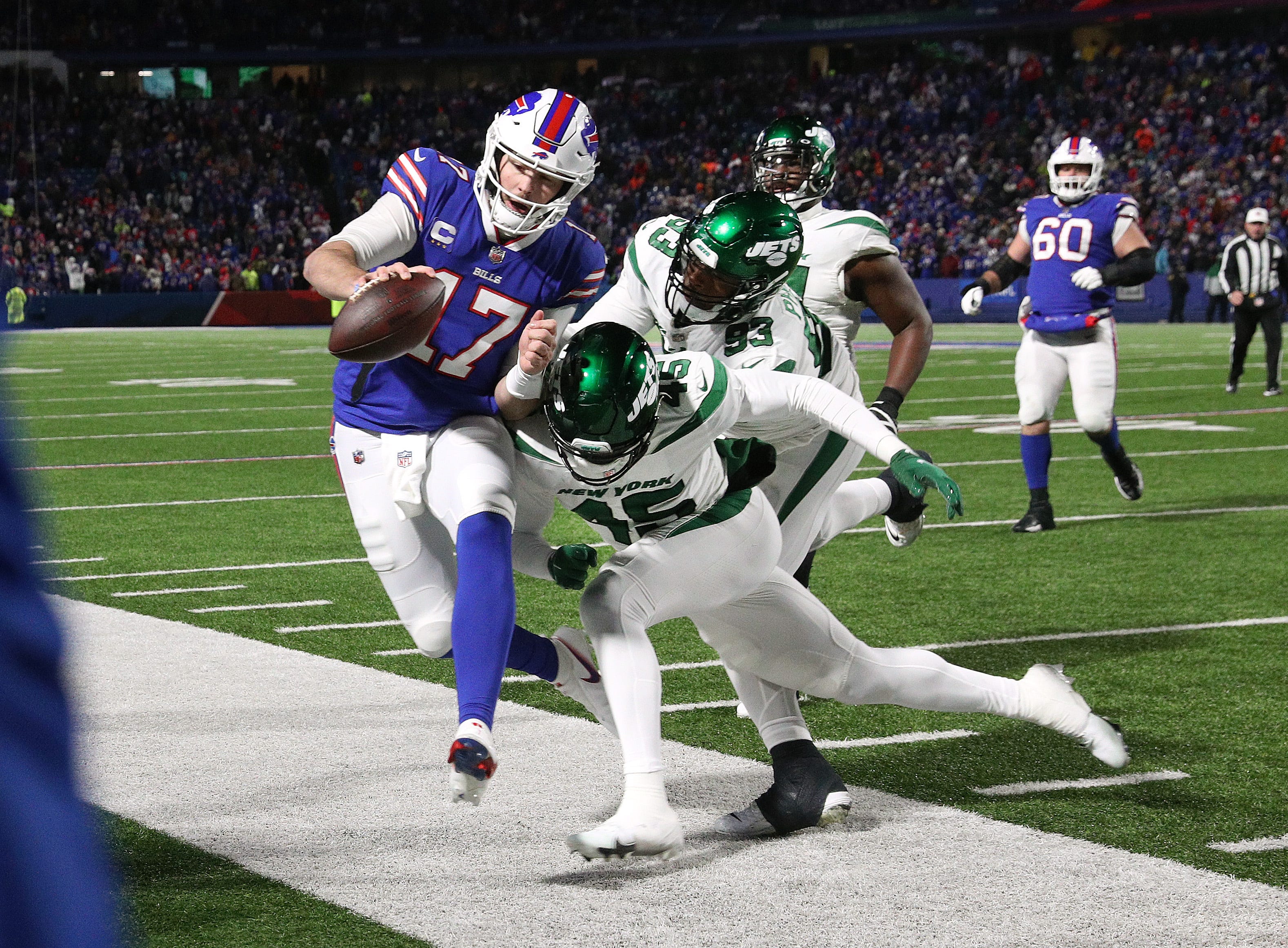 Bills quarterback Josh Allen is hit as he goes out of bounds by Jets Hamsah Nasirildeen. The Bills beat the Jets 27-10 to win the AFC east.