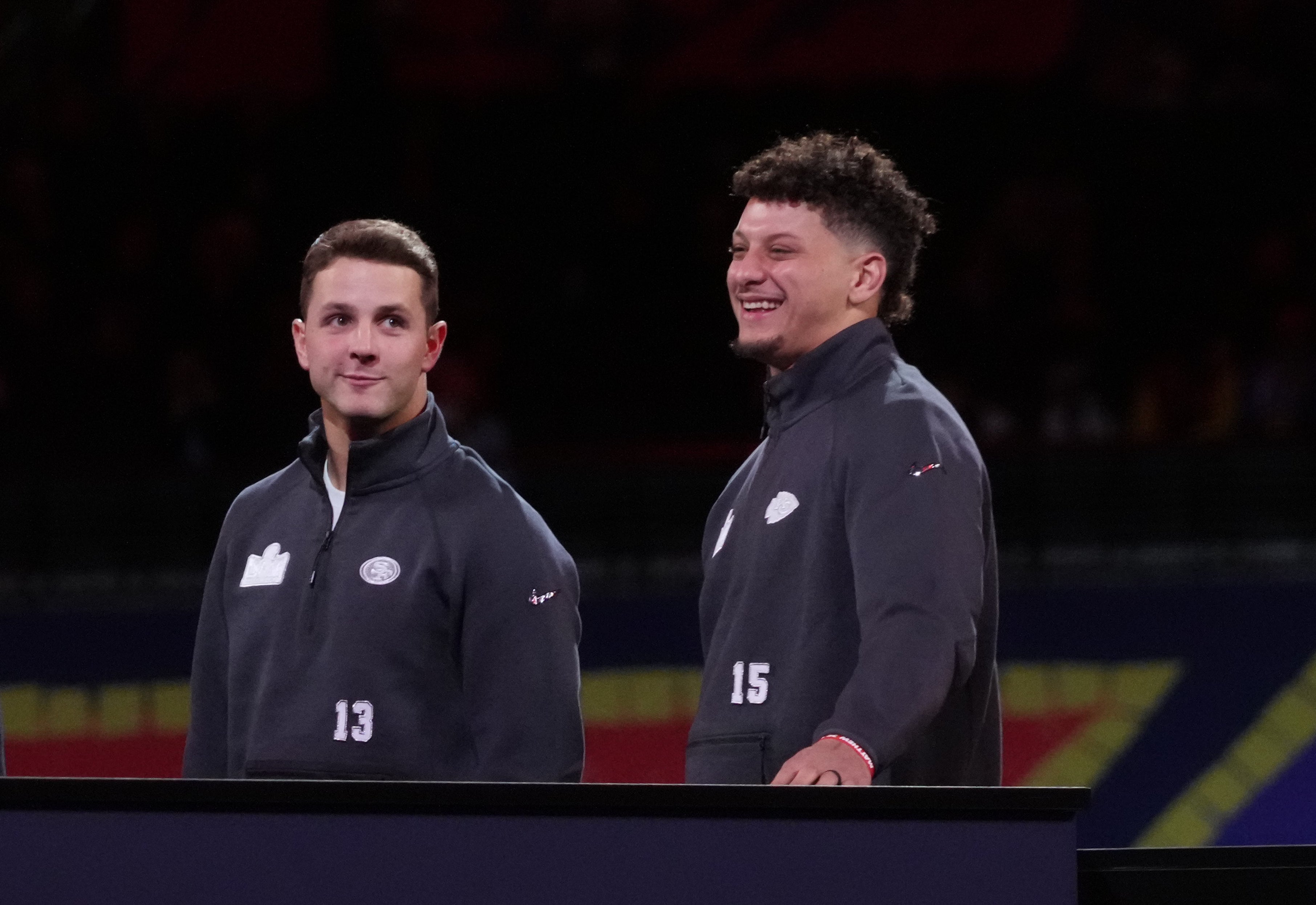 Feb 5, 2024; Las Vegas, NV, USA; San Francisco 49ers quarterback Brock Purdy (13) and Kansas City Chiefs quarterback Patrick Mahomes (15) stand on stage together during Super Bowl LVIII Opening Night at Allegiant Stadium.