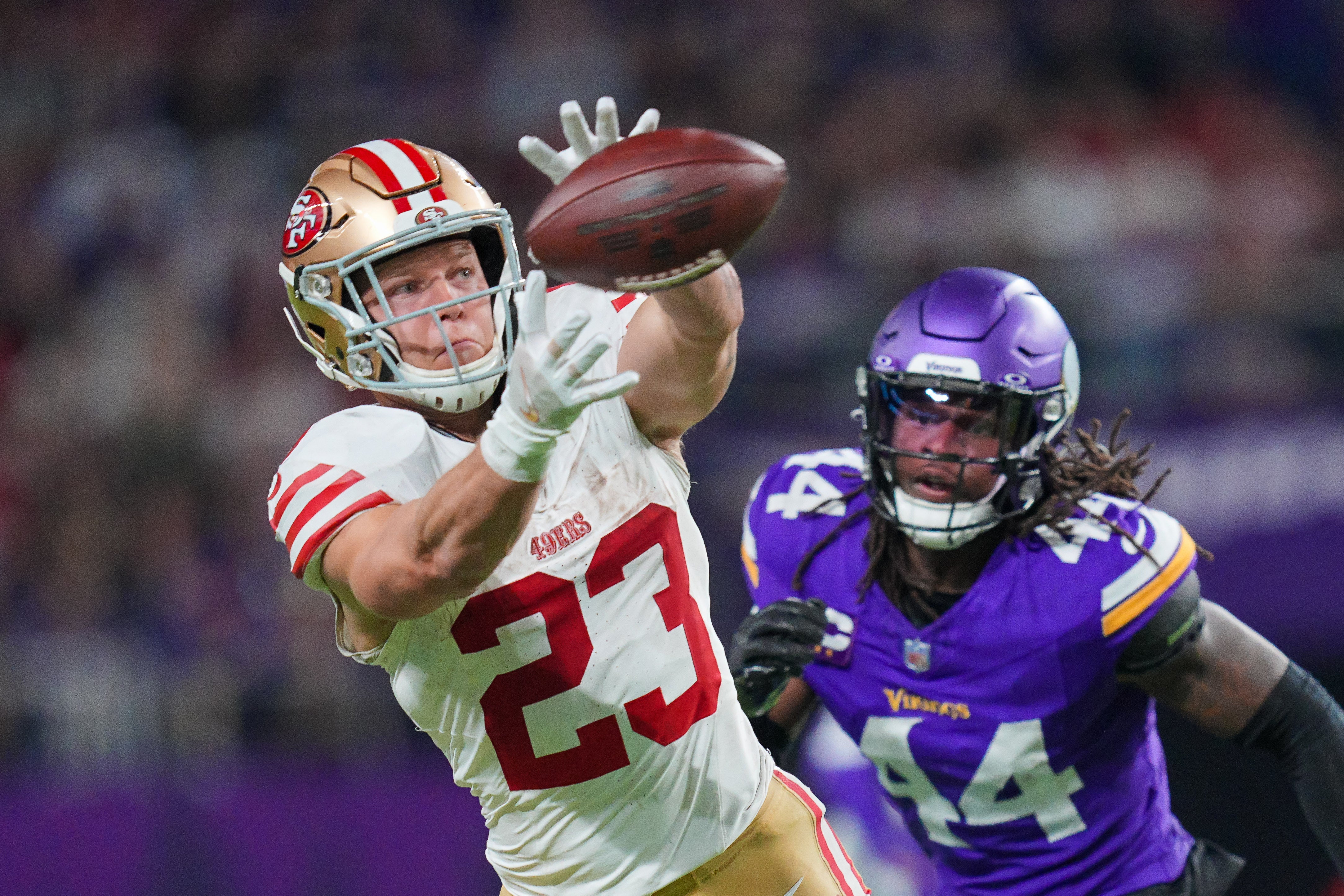 Oct 23, 2023; Minneapolis, Minnesota, USA; San Francisco 49ers running back Christian McCaffrey (23) catches a pass against the Minnesota Vikings in the fourth quarter at U.S. Bank Stadium.