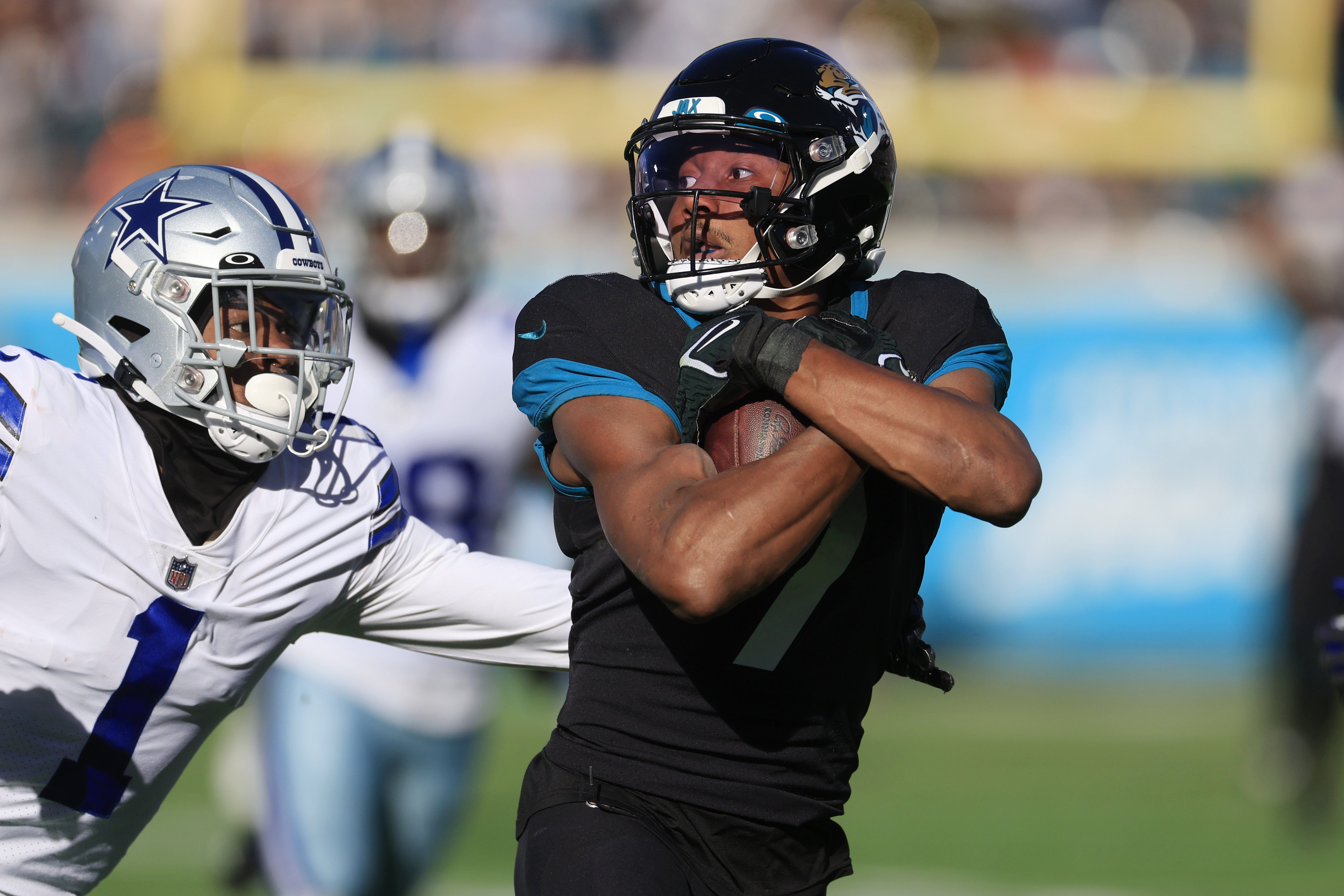 Jacksonville Jaguars wide receiver Zay Jones (7) hauls in a reception for a run and score against Dallas Cowboys cornerback Kelvin Joseph (1) during the third quarter of a regular season NFL football matchup Sunday, Dec. 18, 2022 at TIAA Bank Field in Jacksonville.