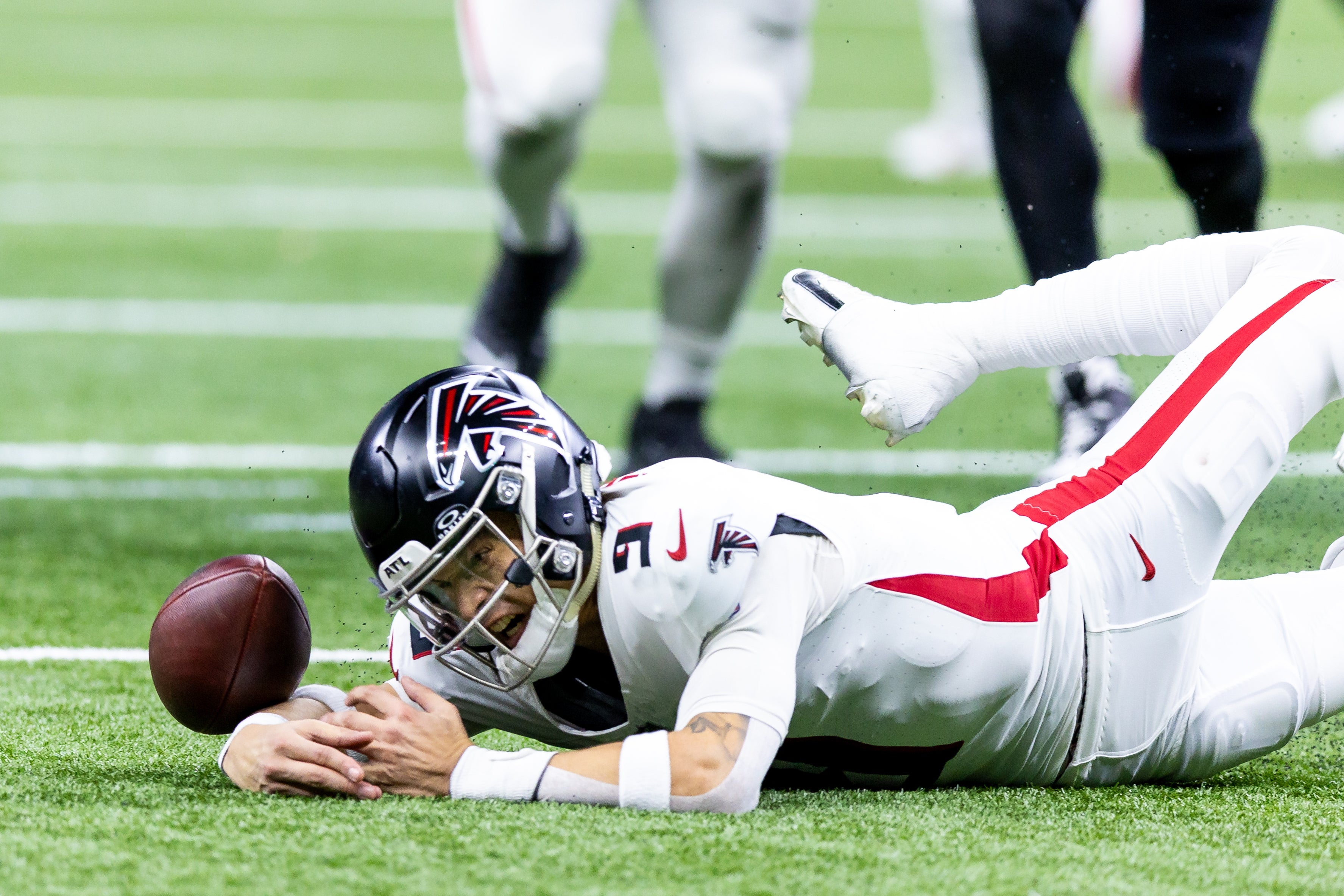 Atlanta Falcons quarterback Desmond Ridder (9) looks the football for a fumble as New Orleans Saints defensive end Payton Turner (98) recovers it during the second half at Caesars Superdome.