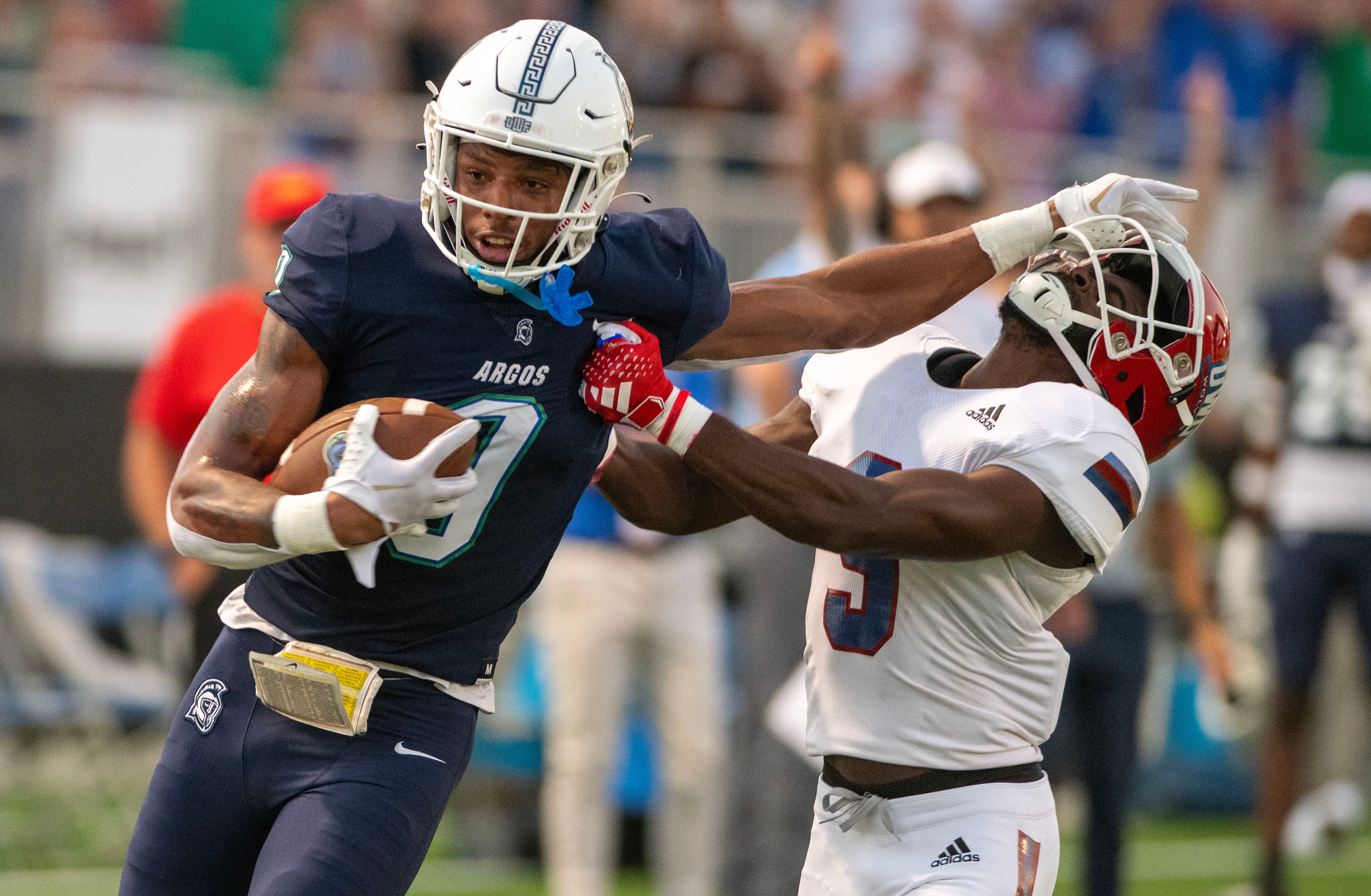 West Florida's John Jiles fends off West Georgia's Camyen Feagins as he goes in for the touch down during the Gulf South Conference opener against West Georgia at Pen Air Field at the University of West Florida Saturday, September 23, 2023.
