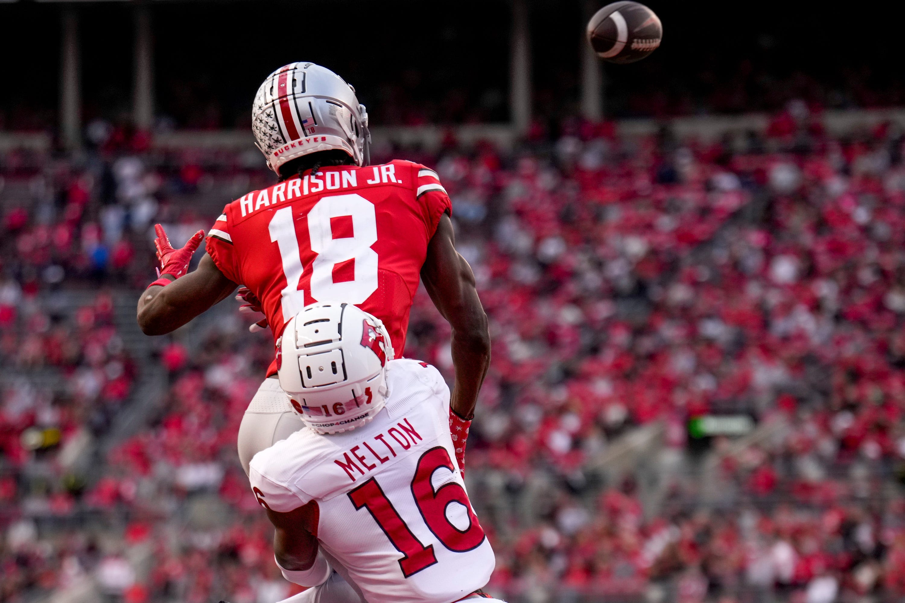 Ohio State Buckeyes wide receiver Marvin Harrison Jr. (18) is defended by Rutgers Scarlet Knights defensive back Max Melton (16) during the third quarter of the NCAA Division I football game between the Ohio State Buckeyes and the Rutgers Scarlet Knights at Ohio Stadium.
