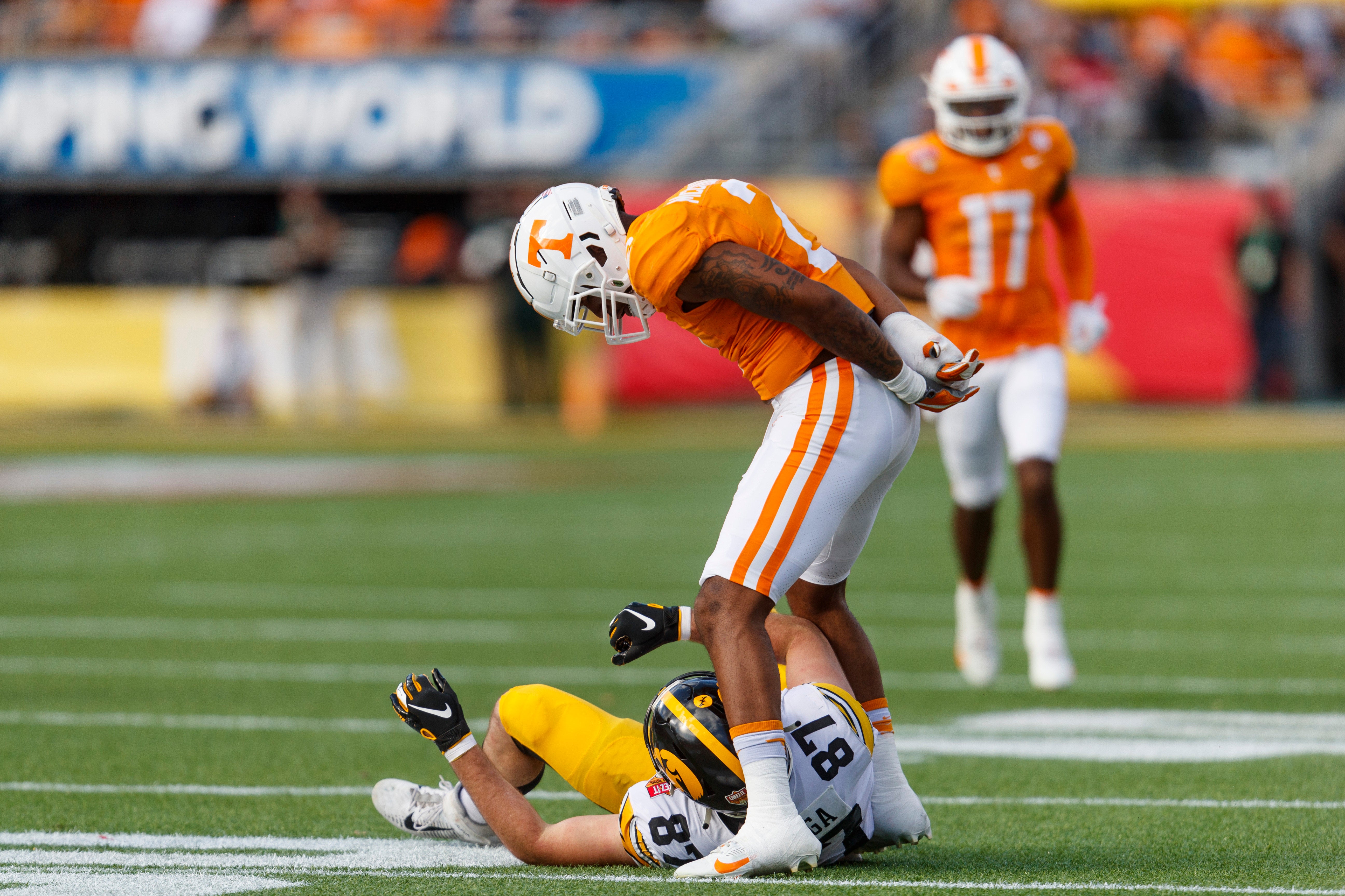 Jan 1, 2024; Orlando, FL, USA; Tennessee Volunteers defensive back Jaylen McCollough (2) stands over Iowa Hawkeyes tight end Addison Ostrenga (87) after a tackle during the third quarter at Camping World Stadium.