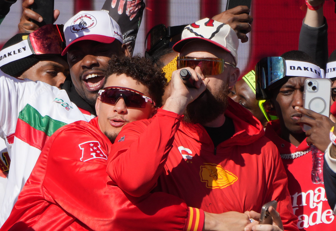Feb 14, 2024; Kansas City, MO, USA; Kansas City Chiefs quarterback Patrick Mahomes (15) embraces tight end Travis Kelce (87) on stage during the celebration of the Kansas City Chiefs winning Super Bowl LVIII.