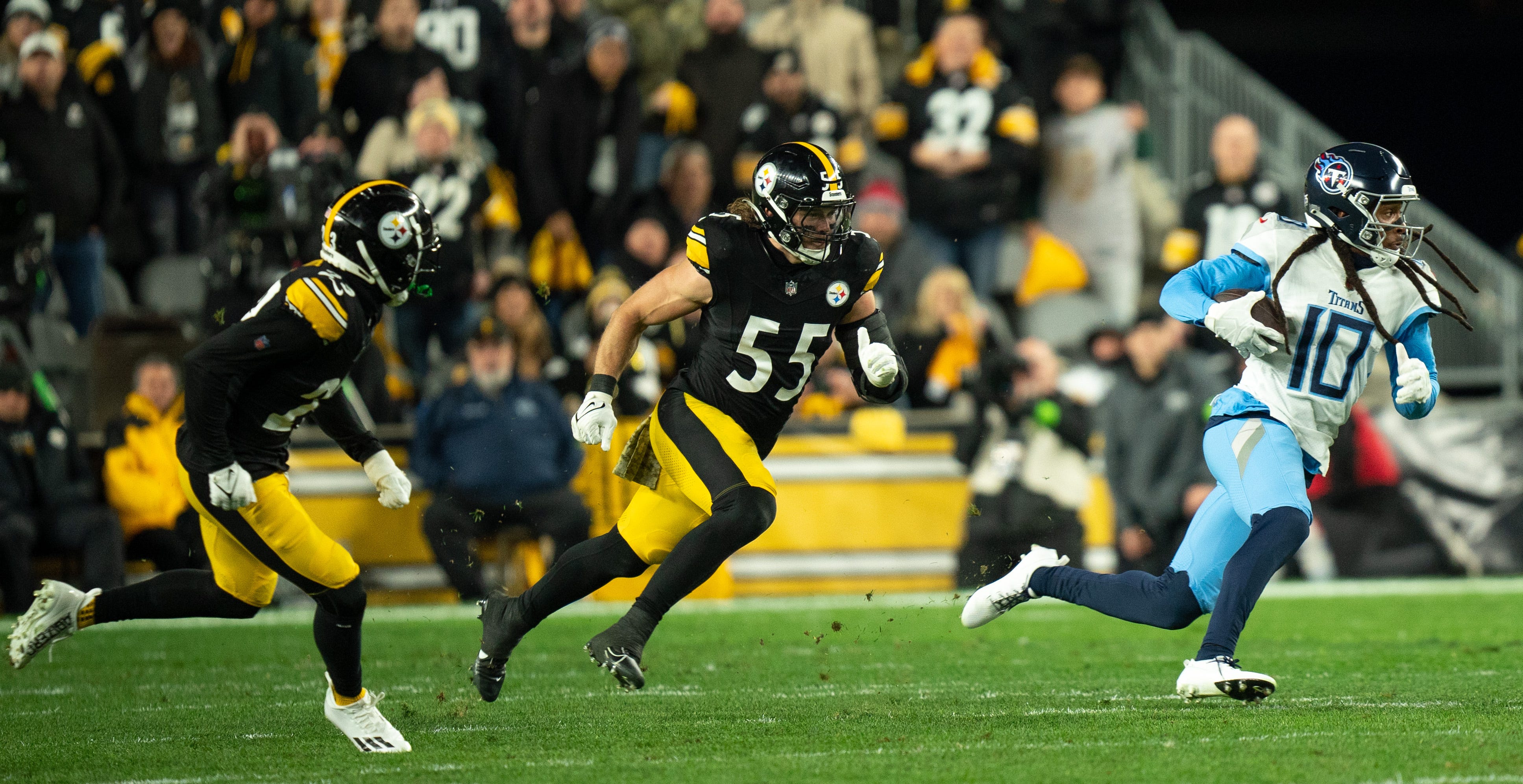 Tennessee Titans wide receiver DeAndre Hopkins (10) runs after the catch with Pittsburgh Steelers linebacker Cole Holcomb (55) in pursuit during their game at Acrisure Stadium in Pittsburgh, Penn., Thursday, Nov. 2, 2023.