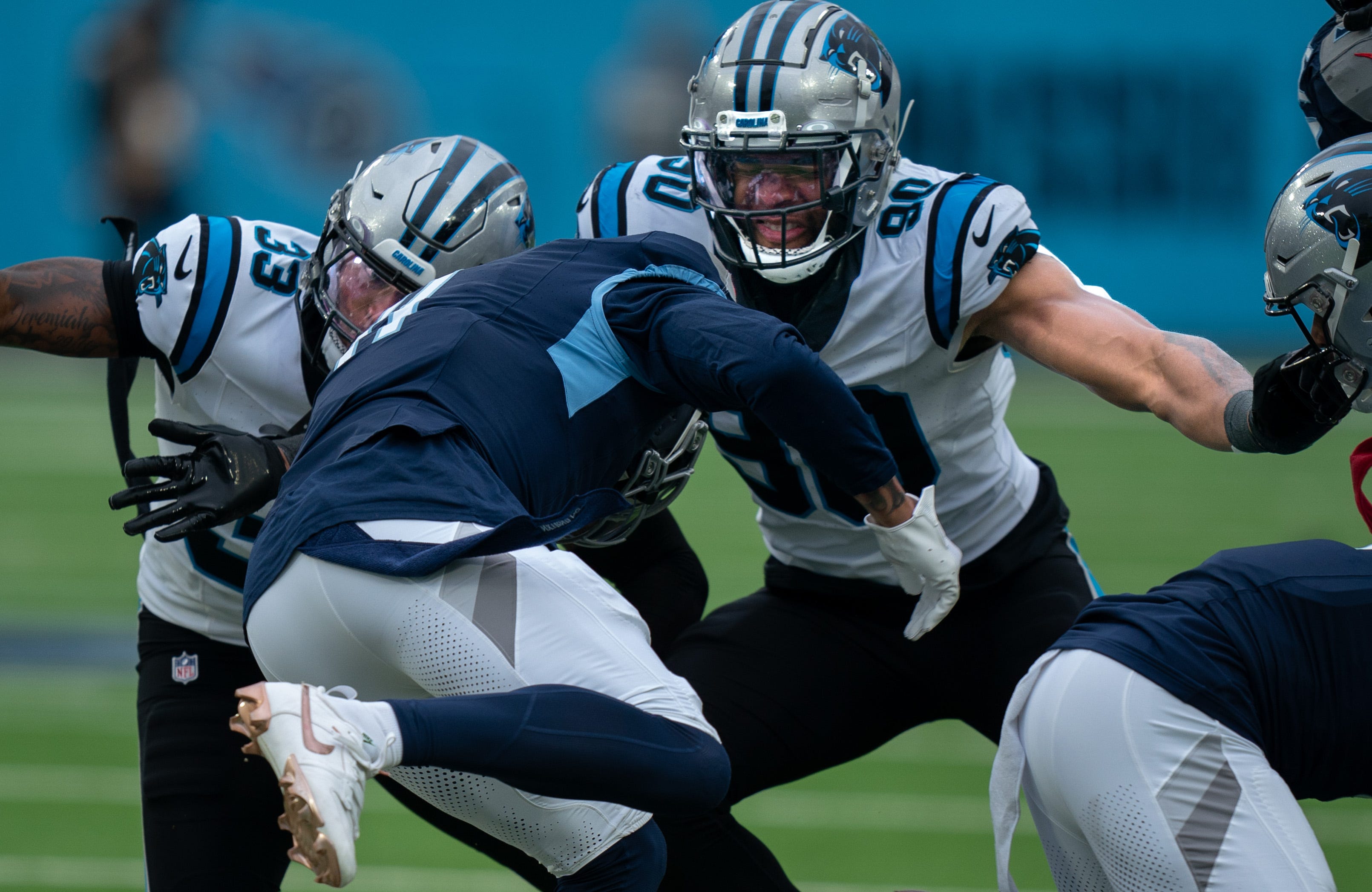 Carolina Panthers linebacker Amare Barno (90) and Tarik Cohen (33) prepare to take the hit of Tennessee Titans wide receiver Chris Moore (11) during their game at Nissan Stadium in Nashville, Tenn., Sunday, Nov. 26, 2023.
