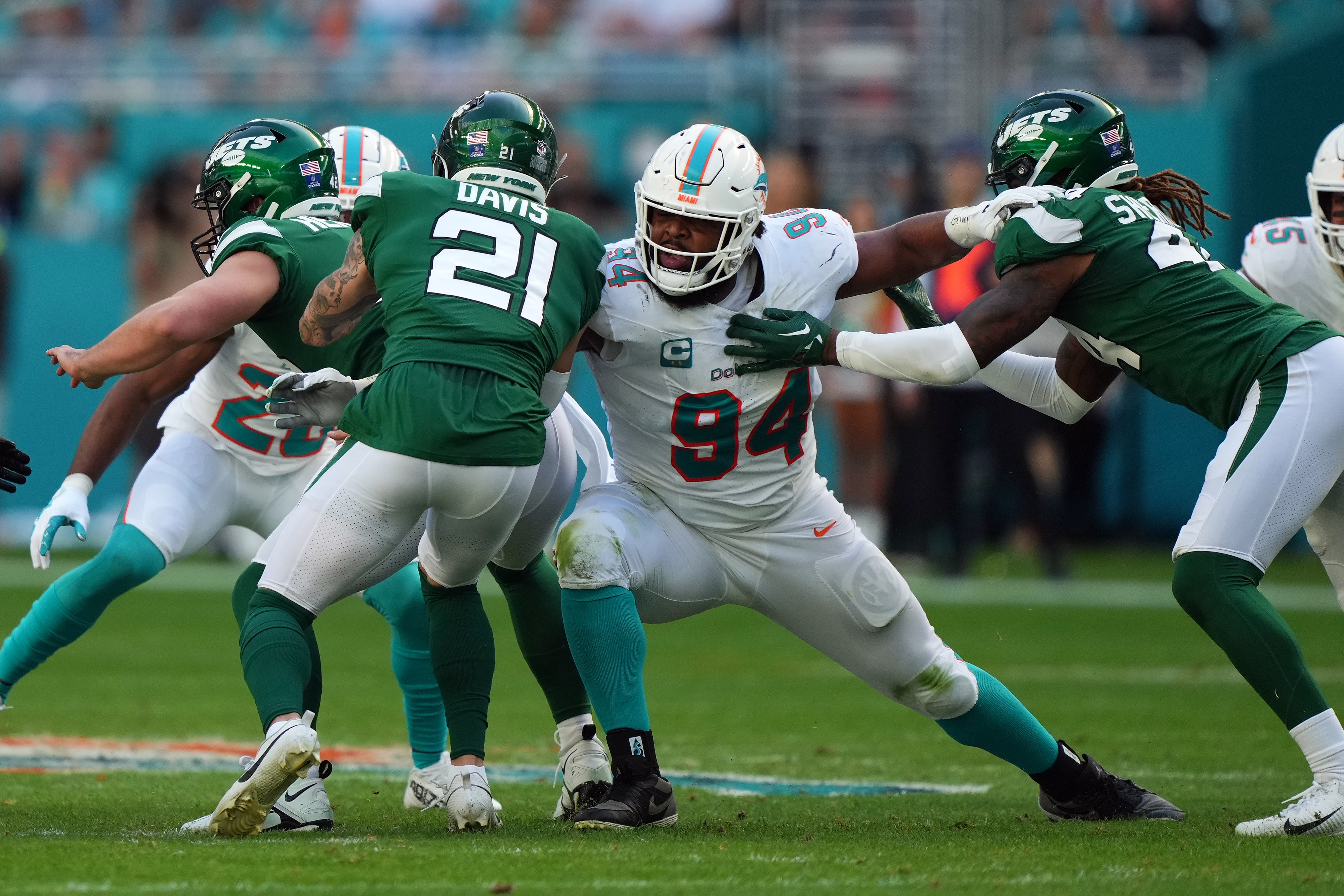 Dec 17, 2023; Miami Gardens, Florida, USA; Miami Dolphins defensive tackle Christian Wilkins (94) reaches for New York Jets safety Ashtyn Davis (21) during the first half at Hard Rock Stadium.