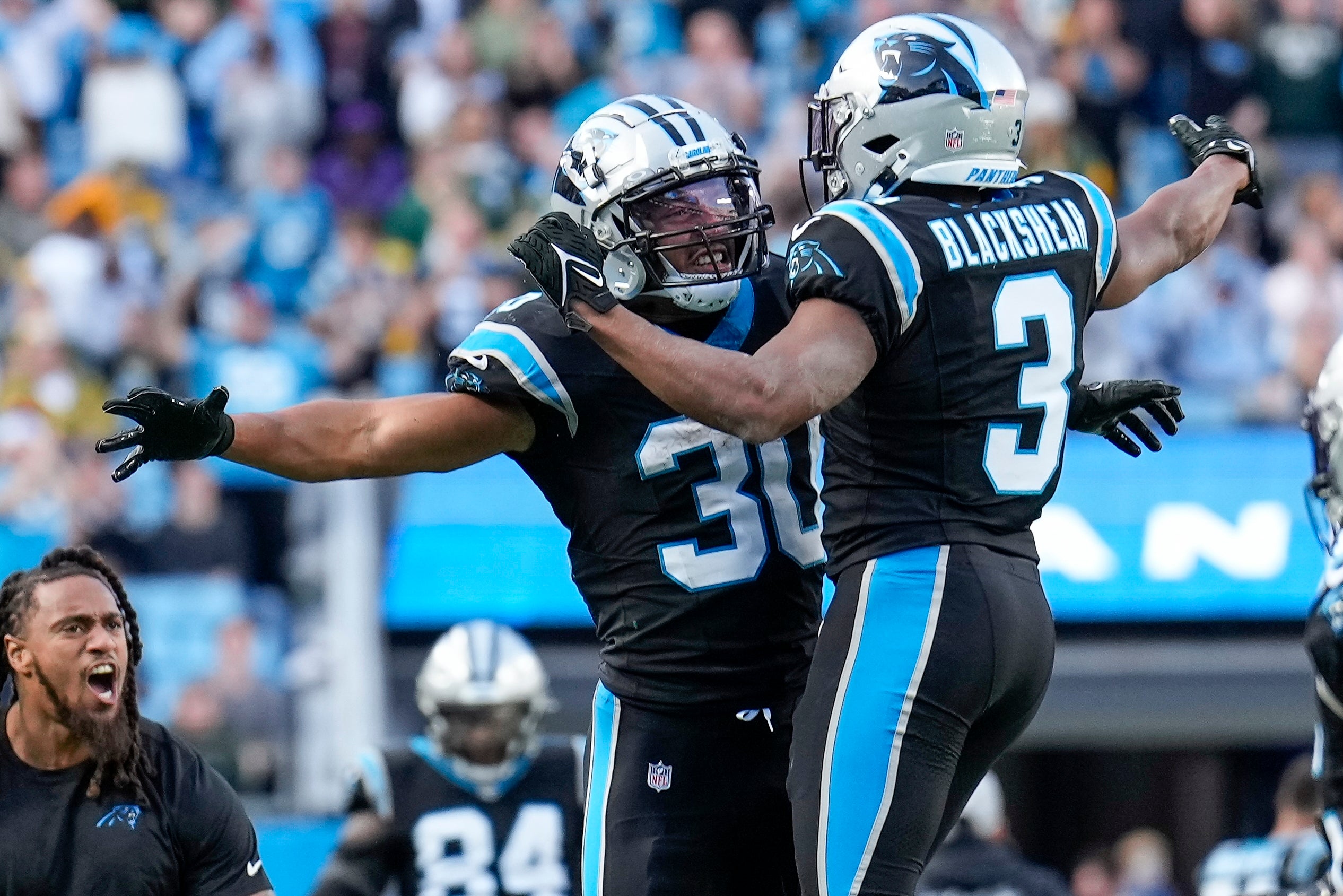 Dec 24, 2023; Charlotte, North Carolina, USA; Carolina Panthers running back Raheem Blackshear (3) and running back Chuba Hubbard (30) react to a score against the Green Bay Packers during the second half at Bank of America Stadium. Mandatory Credit: Jim Dedmon-USA TODAY Sports