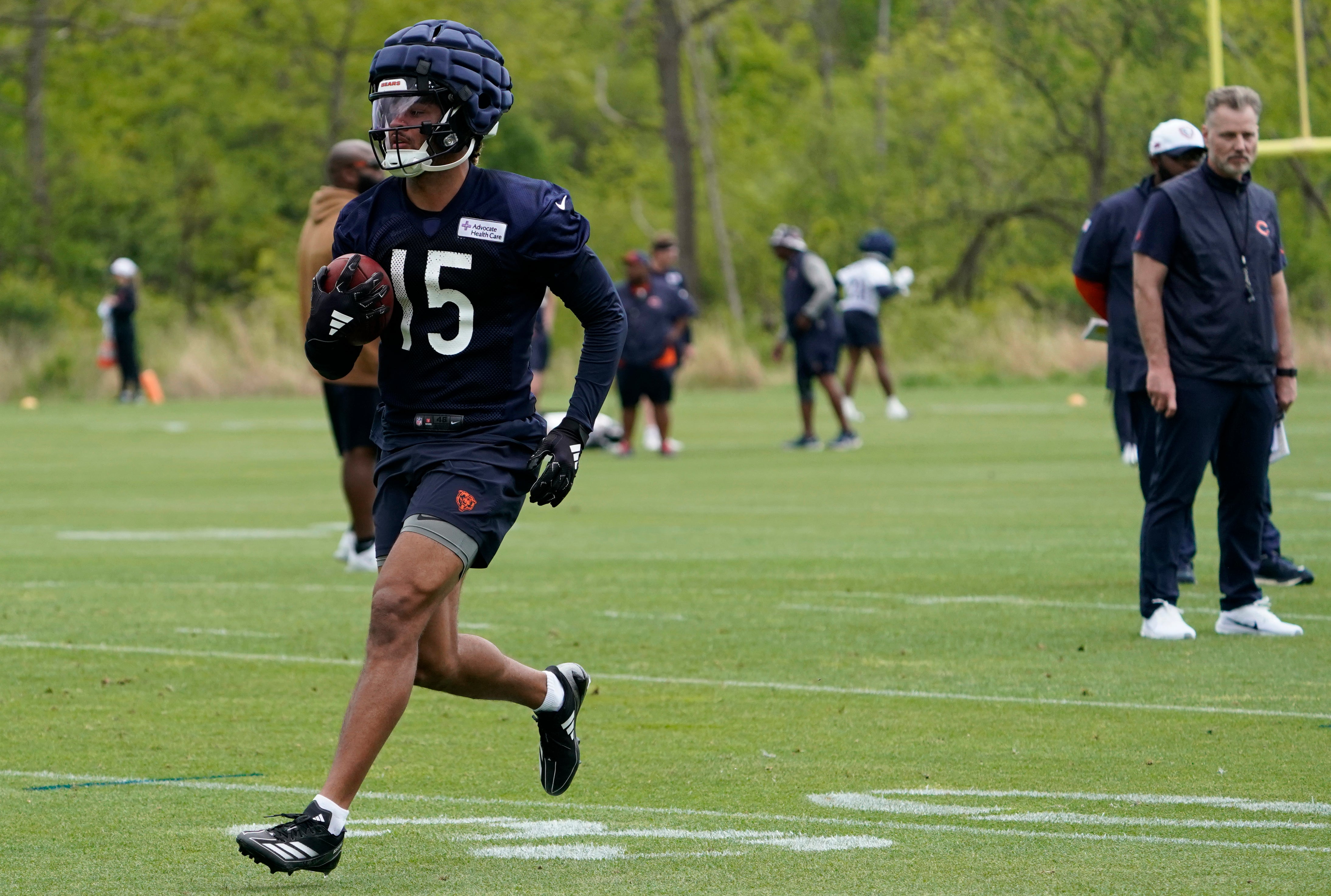 May 10, 2024; Lake Forest, IL, USA; Chicago Bears wide receiver Rome Odunze (15) runs drills as head coach Matt Eberflus looks on during Chicago Bears rookie minicamp at Halas Hall.